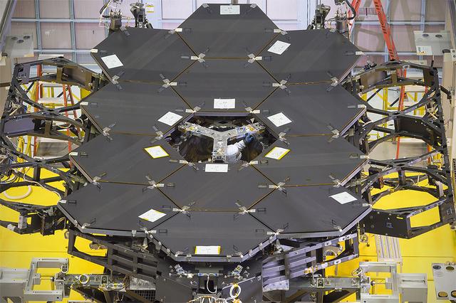 Caption: One dozen (out of 18) flight mirror segments that make up the primary mirror on NASA's James Webb Space Telescope have been installed at NASA's Goddard Space Flight Center.  Credits: NASA/Chris Gunn  More: Since December 2015, the team of scientists and engineers have been working tirelessly to install all the primary mirror segments onto the telescope structure in the large clean room at NASA's Goddard Space Flight Center in Greenbelt, Maryland. The twelfth mirror was installed on January 2, 2016.  &quot;This milestone signifies that all of the hexagonal shaped mirrors on the fixed central section of the telescope structure are installed and only the 3 mirrors on each wing are left for installation,&quot; said Lee Feinberg, NASA's Optical Telescope Element Manager at NASA Goddard. &quot;The incredibly skilled and dedicated team assembling the telescope continues to find ways to do things faster and more efficiently.&quot;  Each hexagonal-shaped segment measures just over 4.2 feet (1.3 meters) across and weighs approximately 88 pounds (40 kilograms). After being pieced together, the 18 primary mirror segments will work together as one large 21.3-foot (6.5-meter) mirror. The primary mirror will unfold and adjust to shape after launch. The mirrors are made of ultra-lightweight beryllium. The mirrors are placed on the telescope's backplane using a robotic arm, guided by engineers. The full installation is expected to be completed in a few months.  The mirrors were built by Ball Aerospace &amp; Technologies Corp., Boulder, Colorado. Ball is the principal subcontractor to Northrop Grumman for the optical technology and lightweight mirror system. The installation of the mirrors onto the telescope structure is performed by Harris Corporation of Rochester, New York. Harris Corporation leads integration and testing for the telescope.  While the mirror assembly is a very significant milestone, there are many more steps involved in assembling the Webb telescope. The primary mirror and the tennis-court-sized sunshield are the largest and most visible components of the Webb telescope. However, there are four smaller components that are less visible, yet critical.  The instruments that will fly aboard Webb - cameras and spectrographs with detectors able to record extremely faint signals — are part of the Integrated Science Instrument Module (ISIM), which is currently undergoing its final cryogenic vacuum test and will be integrated with the mirror later this year. Read more: <a href="http://www.nasa.gov/feature/goddard/2016/by-the-dozen-nasas-james-webb-space-telescope-mirrors" rel="nofollow">www.nasa.gov/feature/goddard/2016/by-the-dozen-nasas-jame...</a>  <b><a href="http://www.nasa.gov/audience/formedia/features/MP_Photo_Guidelines.html" rel="nofollow">NASA image use policy.</a></b>  <b><a href="http://www.nasa.gov/centers/goddard/home/index.html" rel="nofollow">NASA Goddard Space Flight Center</a></b> enables NASA’s mission through four scientific endeavors: Earth Science, Heliophysics, Solar System Exploration, and Astrophysics. Goddard plays a leading role in NASA’s accomplishments by contributing compelling scientific knowledge to advance the Agency’s mission.  <b>Follow us on <a href="http://twitter.com/NASAGoddardPix" rel="nofollow">Twitter</a></b>  <b>Like us on <a href="http://www.facebook.com/pages/Greenbelt-MD/NASA-Goddard/395013845897?ref=tsd" rel="nofollow">Facebook</a></b>  <b>Find us on <a href="http://instagrid.me/nasagoddard/?vm=grid" rel="nofollow">Instagram</a></b>   