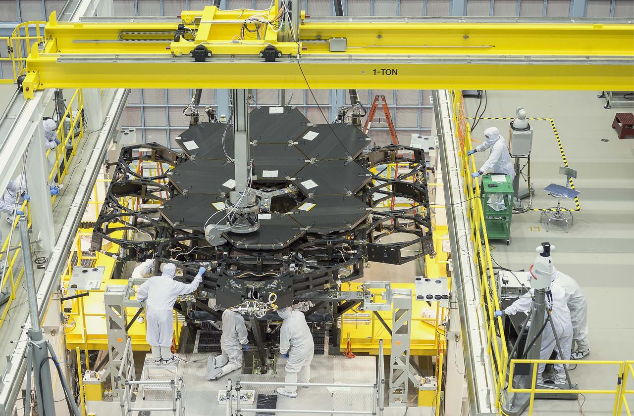 Inside NASA's Goddard Space Flight Center's massive clean room in Greenbelt, Maryland, the ninth flight mirror was installed onto the telescope structure with a robotic arm. This marks the halfway completion point for the James Webb Space Telescope's segmented primary mirror.  This rare overhead shot of the James Webb Space Telescope shows the nine primary flight mirrors installed on the telescope structure in a clean room at NASA's Goddard Space Flight Center in Greenbelt, Maryland.  Credits: NASA's Goddard Space Flight Center/Chris Gunn  Read more: <a href="http://go.nasa.gov/1kqK6fW" rel="nofollow">go.nasa.gov/1kqK6fW</a>