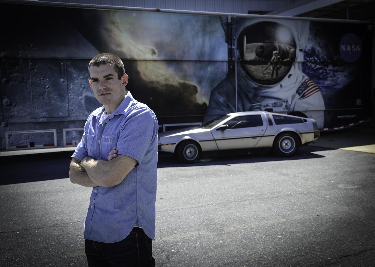 Great Scott, This is Heavy! You might see a DeLorean zipping around Greenbelt, Maryland, on Oct. 21, 2015, the day Marty McFly and Doc Brown arrive from 1985 in "Back to the Future, Part II," but don't look for flaming tread marks in its wake. The DeLorean DMC-12, commonly seen on the roads of NASA’s Goddard Space Flight Center in Greenbelt, Maryland, is better known for the version that starred as a plutonium-powered time machine in the “Back to the Future” trilogy. After some investigation, Goddard’s Office of Communications found the owner of the stainless steel, gull-winged, two-door coupe. Goddard software test engineer, Brendan Rebo bought the 1982 DeLorean off eBay about four and a half years ago. “The car attracts a lot more attention than I expected,” Rebo admitted. “I hear a lot of jokes about whether or not I’ve reached 88 miles per hour yet.” As “Back to the Future” fans around the world celebrate today, Rebo also celebrates his birthday. While the second film predicted technology, such as flying cars, that doesn’t yet exist, people can still marvel at the classic car and movie reference. Credit: NASA/Goddard/Rebecca Roth <b><a href="http://www.nasa.gov/audience/formedia/features/MP_Photo_Guidelines.html" rel="nofollow">NASA image use policy.</a></b> <b><a href="http://www.nasa.gov/centers/goddard/home/index.html" rel="nofollow">NASA Goddard Space Flight Center</a></b> enables NASA’s mission through four scientific endeavors: Earth Science, Heliophysics, Solar System Exploration, and Astrophysics. Goddard plays a leading role in NASA’s accomplishments by contributing compelling scientific knowledge to advance the Agency’s mission. <b>Follow us on <a href="http://twitter.com/NASAGoddardPix" rel="nofollow">Twitter</a></b> <b>Like us on <a href="http://www.facebook.com/pages/Greenbelt-MD/NASA-Goddard/395013845897?ref=tsd" rel="nofollow">Facebook</a></b> <b>Find us on <a href="http://instagrid.me/nasagoddard/?vm=grid" rel="nofollow">Instagram</a></b>