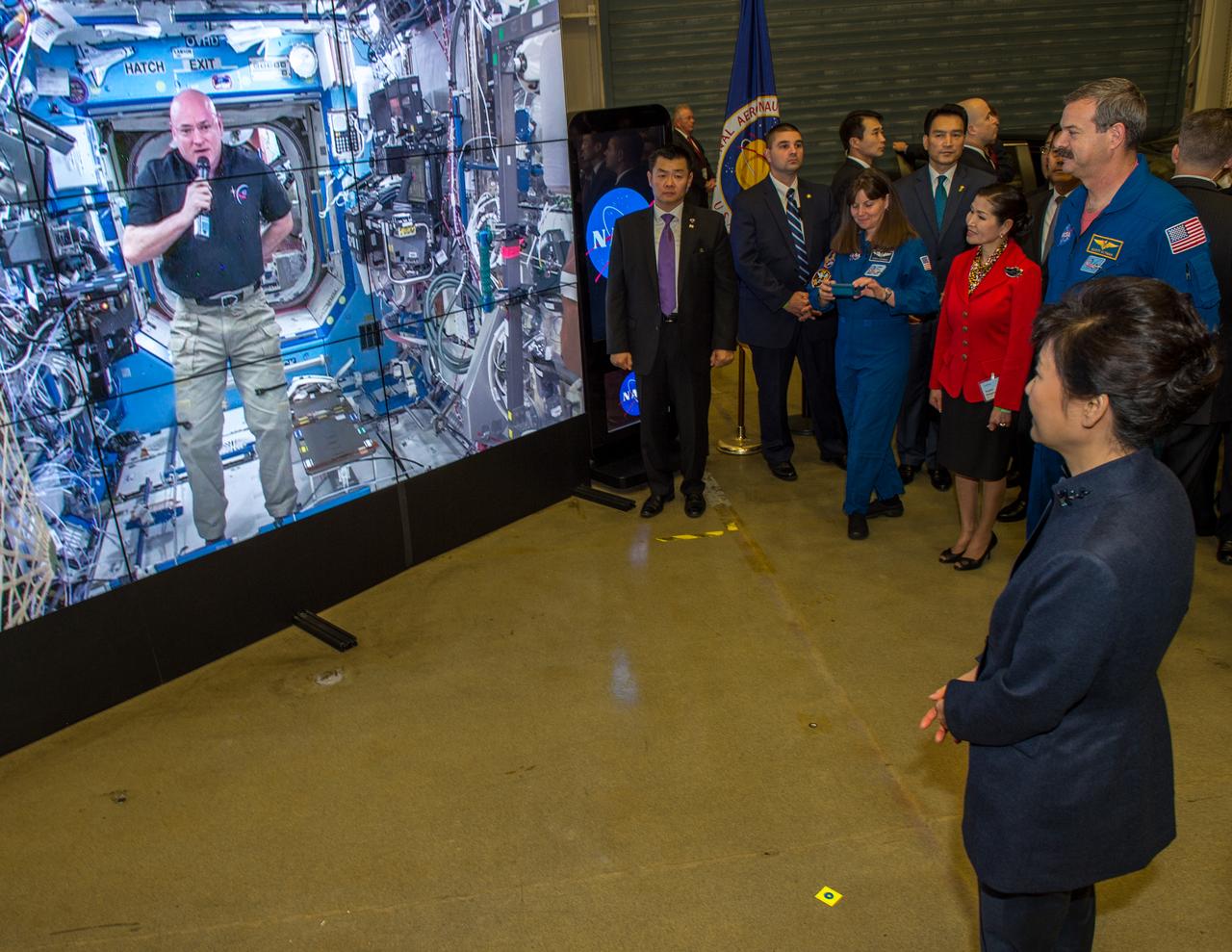 As part of her visit to the United States, President Park Geun-hye of South Korea visited NASA’s Goddard Space Flight Center in Greenbelt, Md. On Oct. 14, 2015. The visit offered an opportunity to celebrate past collaborative efforts between the American and South Korean space programs along with presentations on current projects and programs underway at Goddard. Caption: resident Park Geun-hye of South Korea watches a message sent down from Astronaut Scott Kelly aboard the International Space Station. Kelly who is a little more than halfway thru a year-long stay on ISS welcomed Madam Park to NASA Goddard. Her visit to Goddard offered an opportunity to celebrate past collaborative efforts between the American and South Korean space programs along with presentations on current projects and programs underway at Goddard. Credit: NASA/Goddard/Bill Hrybyk <b><a href="http://www.nasa.gov/audience/formedia/features/MP_Photo_Guidelines.html" rel="nofollow">NASA image use policy.</a></b> <b><a href="http://www.nasa.gov/centers/goddard/home/index.html" rel="nofollow">NASA Goddard Space Flight Center</a></b> enables NASA’s mission through four scientific endeavors: Earth Science, Heliophysics, Solar System Exploration, and Astrophysics. Goddard plays a leading role in NASA’s accomplishments by contributing compelling scientific knowledge to advance the Agency’s mission. <b>Follow us on <a href="http://twitter.com/NASAGoddardPix" rel="nofollow">Twitter</a></b> <b>Like us on <a href="http://www.facebook.com/pages/Greenbelt-MD/NASA-Goddard/395013845897?ref=tsd" rel="nofollow">Facebook</a></b> <b>Find us on <a href="http://instagrid.me/nasagoddard/?vm=grid" rel="nofollow">Instagram</a></b>