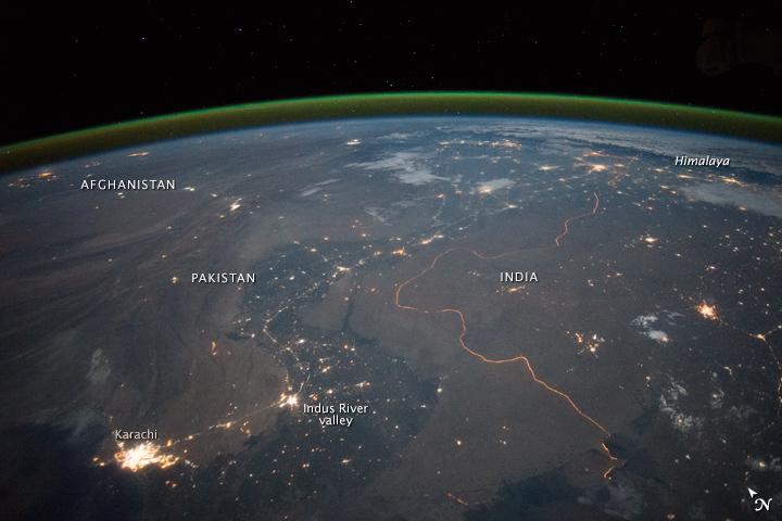 An astronaut aboard the International Space Station took this nighttime panorama while looking north across Pakistan’s Indus River valley. The port city of Karachi is the bright cluster of lights facing the Arabian Sea, which appears completely black. City lights and the dark color of dense agriculture closely track with the great curves of the Indus valley. For scale, the distance from Karachi to the foothills of the Himalaya Mountains is 1,160 kilometers (720 miles).  This photograph shows one of the few places on Earth where an international boundary can be seen at night. The winding border between Pakistan and India is lit by security lights that have a distinct orange tone.  Astronaut photograph ISS045-E-27869 was acquired on September 23, 2015, with a Nikon D4 digital camera using a 28 millimeter lens, and is provided by the ISS Crew Earth Observations Facility and the Earth Science and Remote Sensing Unit, Johnson Space Center.  via NASA Earth Observatory  Read more: <a href="http://earthobservatory.nasa.gov/IOTD/view.php?id=86725&amp;eocn=home&amp;eoci=iotd_title" rel="nofollow">earthobservatory.nasa.gov/IOTD/view.php?id=86725&amp;eocn...</a> 