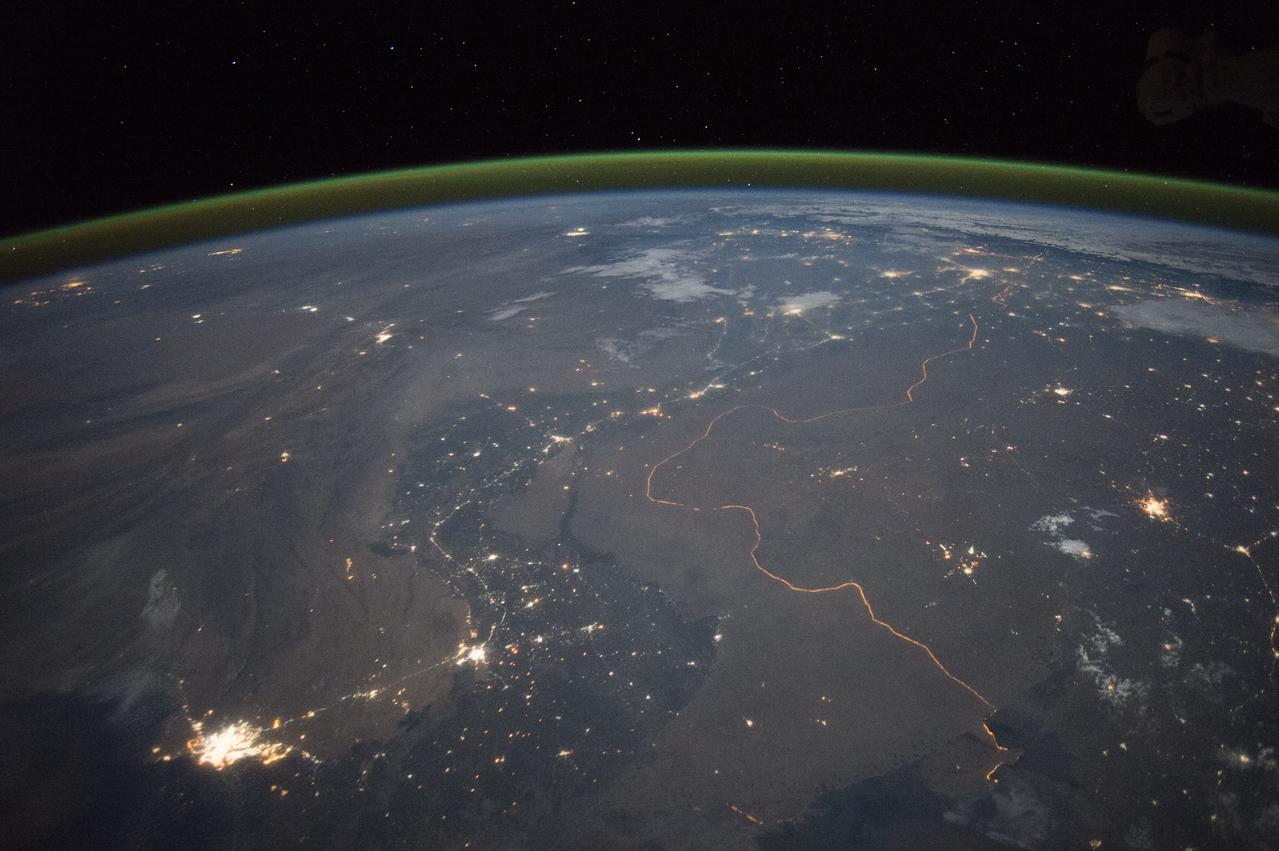An astronaut aboard the International Space Station took this nighttime panorama while looking north across Pakistan’s Indus River valley. The port city of Karachi is the bright cluster of lights facing the Arabian Sea, which appears completely black. City lights and the dark color of dense agriculture closely track with the great curves of the Indus valley. For scale, the distance from Karachi to the foothills of the Himalaya Mountains is 1,160 kilometers (720 miles).  This photograph shows one of the few places on Earth where an international boundary can be seen at night. The winding border between Pakistan and India is lit by security lights that have a distinct orange tone.  Astronaut photograph ISS045-E-27869 was acquired on September 23, 2015, with a Nikon D4 digital camera using a 28 millimeter lens, and is provided by the ISS Crew Earth Observations Facility and the Earth Science and Remote Sensing Unit, Johnson Space Center.  via NASA Earth Observatory  Read more: <a href="http://earthobservatory.nasa.gov/IOTD/view.php?id=86725&amp;eocn=home&amp;eoci=iotd_title" rel="nofollow">earthobservatory.nasa.gov/IOTD/view.php?id=86725&amp;eocn...</a> 