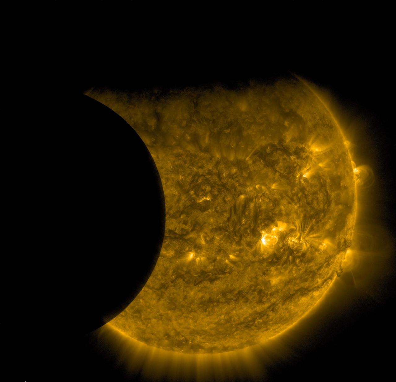 NASA’s Solar Dynamics Observatory captured this image of Earth and the moon transiting the sun together on Sept. 13, 2015. The edge of Earth, visible near the top of the frame, appears fuzzy because Earth’s atmosphere blocks different amounts of light at different altitudes. On the left, the moon’s edge is perfectly crisp, because it has no atmosphere. This image was taken in extreme ultraviolet wavelengths of 171 angstroms. Though this light is invisible to our eyes, it is typically colorized in gold. Read more: <a href="http://www.nasa.gov/feature/goddard/nasas-sdo-catches-a-double-photobomb" rel="nofollow">www.nasa.gov/feature/goddard/nasas-sdo-catches-a-double-p...</a> Credits: NASA/SDO <b><a href="http://www.nasa.gov/audience/formedia/features/MP_Photo_Guidelines.html" rel="nofollow">NASA image use policy.</a></b> <b><a href="http://www.nasa.gov/centers/goddard/home/index.html" rel="nofollow">NASA Goddard Space Flight Center</a></b> enables NASA’s mission through four scientific endeavors: Earth Science, Heliophysics, Solar System Exploration, and Astrophysics. Goddard plays a leading role in NASA’s accomplishments by contributing compelling scientific knowledge to advance the Agency’s mission. <b>Follow us on <a href="http://twitter.com/NASAGoddardPix" rel="nofollow">Twitter</a></b> <b>Like us on <a href="http://www.facebook.com/pages/Greenbelt-MD/NASA-Goddard/395013845897?ref=tsd" rel="nofollow">Facebook</a></b> <b>Find us on <a href="http://instagrid.me/nasagoddard/?vm=grid" rel="nofollow">Instagram</a></b>