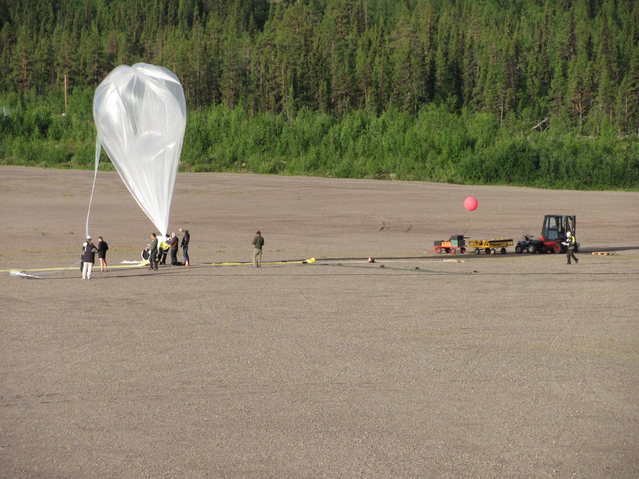 The BARREL team inflates their second balloon just before its launch on Aug. 13, 2015, from Kiruna, Sweden. The day before this launch, the BARREL team successfully recovered the payload from the first balloon launch on Aug. 10. Payload recovery is especially important for this second launch, which carries an instrument and recorded data from a University of Houston team of student scientists.   The NASA-funded BARREL – which stands for Balloon Array for Radiation-belt Relativistic Electron Losses – measures electrons in the atmosphere near the poles.  Such electrons rain down into the atmosphere from two giant radiation belts surrounding Earth, called the Van Allen belts. For its third campaign, BARREL is launching six balloons from the Esrange Space Center in Kiruna, Sweden. BARREL is led by Dartmouth College in Hanover, New Hampshire.  Credit: NASA/Dartmouth/Alexa Halford <b><a href="http://www.nasa.gov/audience/formedia/features/MP_Photo_Guidelines.html" rel="nofollow">NASA image use policy.</a></b>  <b><a href="http://www.nasa.gov/centers/goddard/home/index.html" rel="nofollow">NASA Goddard Space Flight Center</a></b> enables NASA’s mission through four scientific endeavors: Earth Science, Heliophysics, Solar System Exploration, and Astrophysics. Goddard plays a leading role in NASA’s accomplishments by contributing compelling scientific knowledge to advance the Agency’s mission.  <b>Follow us on <a href="http://twitter.com/NASAGoddardPix" rel="nofollow">Twitter</a></b>  <b>Like us on <a href="http://www.facebook.com/pages/Greenbelt-MD/NASA-Goddard/395013845897?ref=tsd" rel="nofollow">Facebook</a></b>  <b>Find us on <a href="http://instagrid.me/nasagoddard/?vm=grid" rel="nofollow">Instagram</a></b>                  