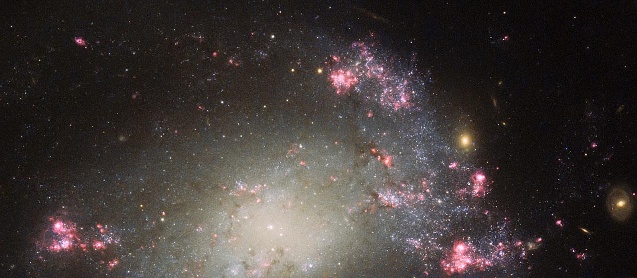 Bursts of pink and red, dark lanes of mottled cosmic dust, and a bright scattering of stars — this NASA/ESA Hubble Space Telescope image shows part of a messy barred spiral galaxy known as NGC 428. It lies approximately 48 million light-years away from Earth in the constellation of Cetus (The Sea Monster).  Although a spiral shape is still just about visible in this close-up shot, overall NGC 428’s spiral structure appears to be quite distorted and warped, thought to be a result of a collision between two galaxies. There also appears to be a substantial amount of star formation occurring within NGC 428 — another telltale sign of a merger. When galaxies collide their clouds of gas can merge, creating intense shocks and hot pockets of gas, and often triggering new waves of star formation.  NGC 428 was discovered by William Herschel in December 1786. More recently a type of supernova designated SN2013ct was discovered within the galaxy by Stuart Parker of the BOSS (Backyard Observatory Supernova Search) project in Australia and New Zealand, although it is unfortunately not visible in this image.  This image was captured by Hubble’s Advanced Camera for Surveys (ACS) and Wide Field and Planetary Camera 2 (WFPC2).    Image credit: ESA/Hubble and NASA and S. Smartt (Queen's University Belfast), Acknowledgements: Nick Rose and Flickr user pennine cloud  <b><a href="http://www.nasa.gov/audience/formedia/features/MP_Photo_Guidelines.html" rel="nofollow">NASA image use policy.</a></b>  <b><a href="http://www.nasa.gov/centers/goddard/home/index.html" rel="nofollow">NASA Goddard Space Flight Center</a></b> enables NASA’s mission through four scientific endeavors: Earth Science, Heliophysics, Solar System Exploration, and Astrophysics. Goddard plays a leading role in NASA’s accomplishments by contributing compelling scientific knowledge to advance the Agency’s mission.  <b>Follow us on <a href="http://twitter.com/NASAGoddardPix" rel="nofollow">Twitter</a></b>  <b>Like us on <a href="http://www.facebook.com/pages/Greenbelt-MD/NASA-Goddard/395013845897?ref=tsd" rel="nofollow">Facebook</a></b>  <b>Find us on <a href="http://instagrid.me/nasagoddard/?vm=grid" rel="nofollow">Instagram</a></b>