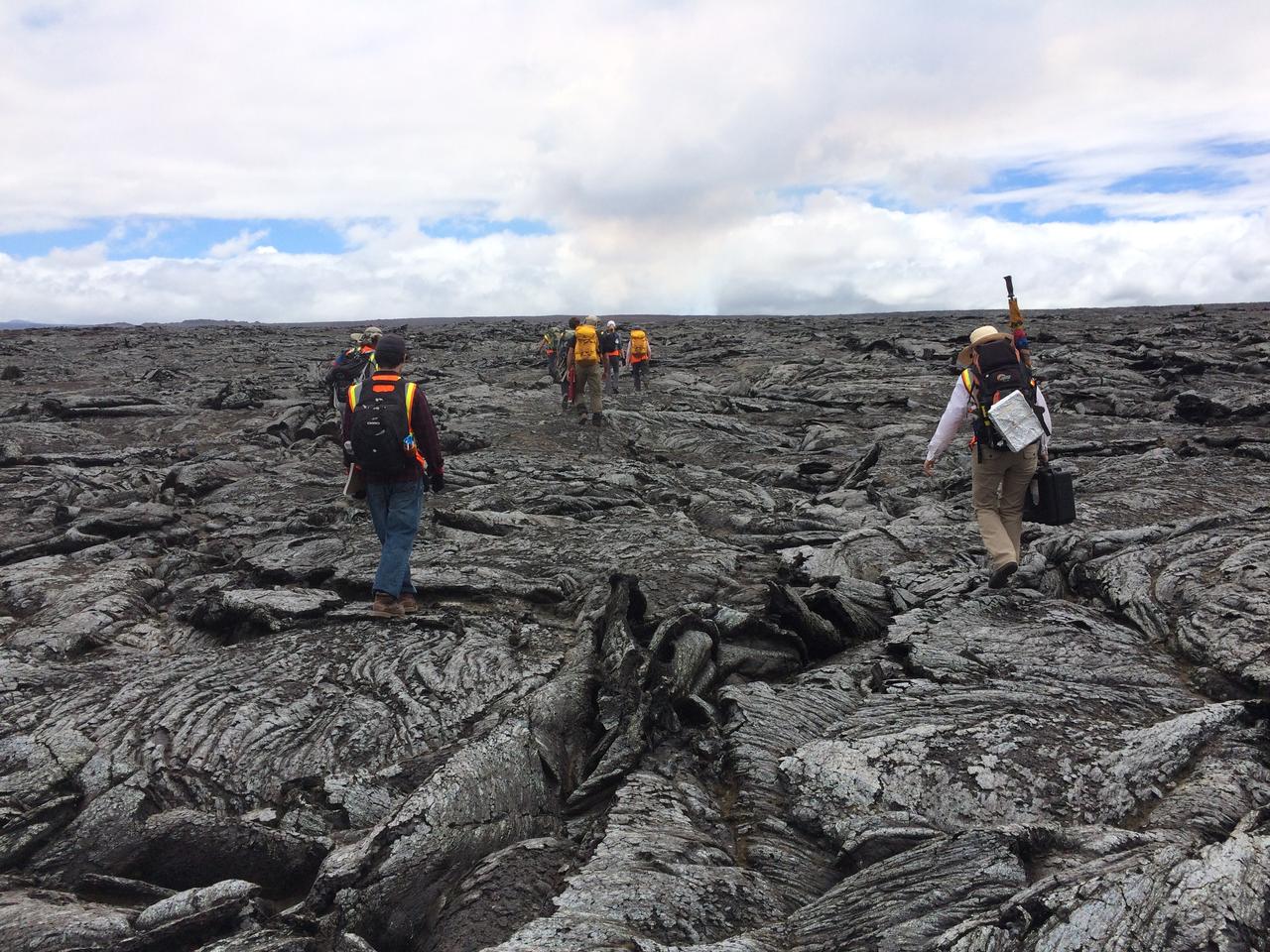 Lava formations  The science and journalism teams make their way across the ropey, twisted, broken crust of the 1978 lava flow. These patterns formed as flowing lava exposed at the surface cooled and solidified, while hot lava continued to flow beneath. The dark cloud in the distance is the active volcanic plume.  Credit: NASA/GSFC/Andrea Jones   In June, five student journalists from Stony Brook University  packed their hiking boots and hydration packs and joined a NASA-funded science team for 10 days on the lava fields of Kilauea, an active Hawaiian volcano. Kilauea’s lava fields are an ideal place to test equipment designed for use on Earth’s moon or Mars, because volcanic activity shaped so much of those terrains. The trip was part of an interdisciplinary program called RIS4E – short for Remote, In Situ, and Synchrotron Studies for Science and Exploration – which is designed to prepare for future exploration of the moon, near-Earth asteroids and the moons of Mars.   To read reports from the RIS4E journalism students about their experiences in Hawaii, visit <a href="http://ReportingRIS4E.com" rel="nofollow">ReportingRIS4E.com</a> <b><a href="http://www.nasa.gov/audience/formedia/features/MP_Photo_Guidelines.html" rel="nofollow">NASA image use policy.</a></b>  <b><a href="http://www.nasa.gov/centers/goddard/home/index.html" rel="nofollow">NASA Goddard Space Flight Center</a></b> enables NASA’s mission through four scientific endeavors: Earth Science, Heliophysics, Solar System Exploration, and Astrophysics. Goddard plays a leading role in NASA’s accomplishments by contributing compelling scientific knowledge to advance the Agency’s mission.  <b>Follow us on <a href="http://twitter.com/NASAGoddardPix" rel="nofollow">Twitter</a></b>  <b>Like us on <a href="http://www.facebook.com/pages/Greenbelt-MD/NASA-Goddard/395013845897?ref=tsd" rel="nofollow">Facebook</a></b>  <b>Find us on <a href="http://instagrid.me/nasagoddard/?vm=grid" rel="nofollow">Instagram</a></b> 
