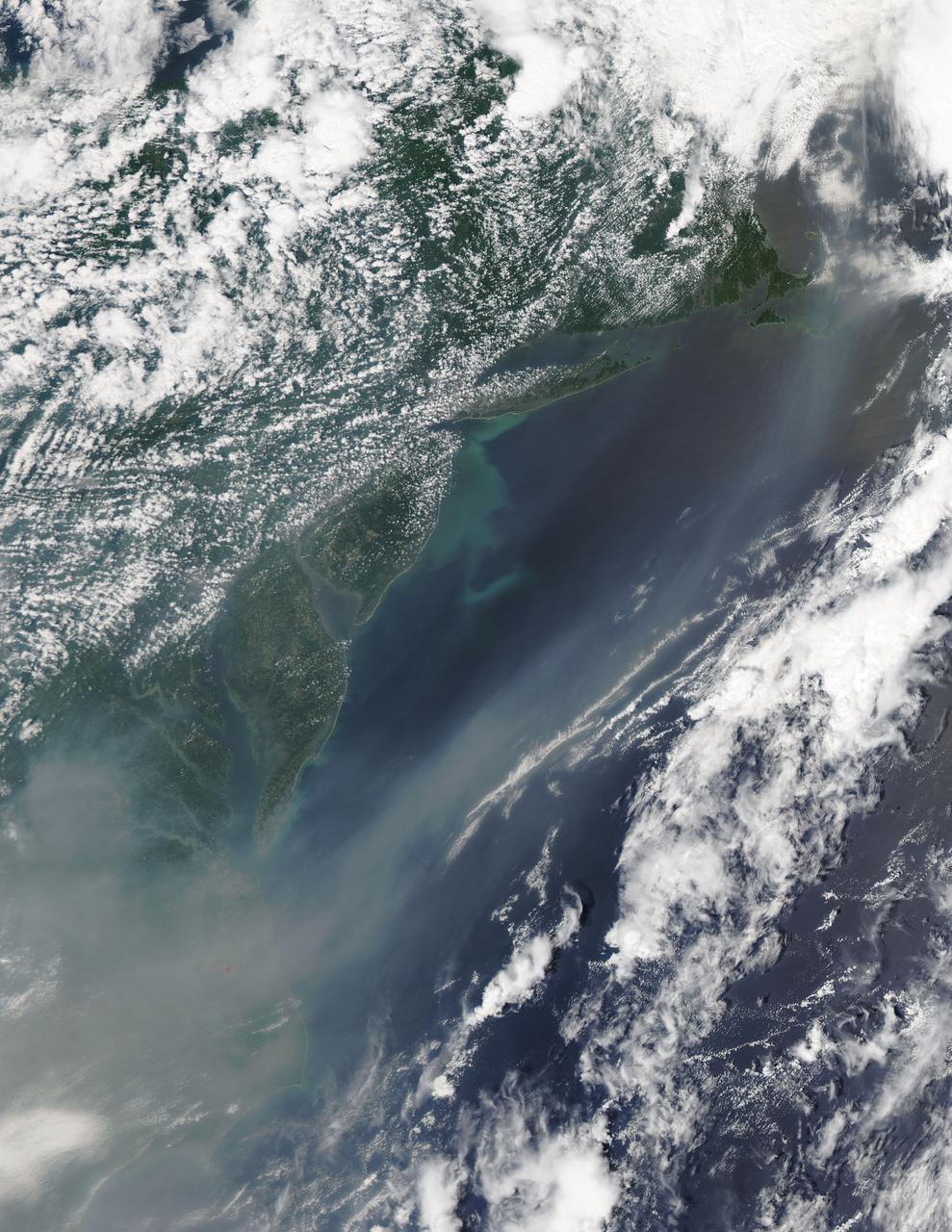 The smoke from the Canadian wildfires that was in the middle of the U.S. on June 30 has drifted its way to the East Coast obscuring parts of the coast from New Jersey to North Carolina.  Images taken on June 30 showed the smoke covering states from Minnesota to Tennessee.  The jet stream has pushed the smoke along so that by July 1 it reached the U.S. East Coast.  Residents of the area will get a preview of July 4th fireworks with redder than usual sunrises and sunsets due to particulates in the air.   This natural-color satellite image was collected by the Moderate Resolution Imaging Spectroradiometer (MODIS) aboard the Aqua satellite on July 1, 2015.    Credit: NASA/GSFC/Jeff Schmaltz/MODIS Land Rapid Response Team  <b><a href="http://www.nasa.gov/audience/formedia/features/MP_Photo_Guidelines.html" rel="nofollow">NASA image use policy.</a></b>  <b><a href="http://www.nasa.gov/centers/goddard/home/index.html" rel="nofollow">NASA Goddard Space Flight Center</a></b> enables NASA’s mission through four scientific endeavors: Earth Science, Heliophysics, Solar System Exploration, and Astrophysics. Goddard plays a leading role in NASA’s accomplishments by contributing compelling scientific knowledge to advance the Agency’s mission.  <b>Follow us on <a href="http://twitter.com/NASAGoddardPix" rel="nofollow">Twitter</a></b>  <b>Like us on <a href="http://www.facebook.com/pages/Greenbelt-MD/NASA-Goddard/395013845897?ref=tsd" rel="nofollow">Facebook</a></b>  <b>Find us on <a href="http://instagrid.me/nasagoddard/?vm=grid" rel="nofollow">Instagram</a></b>