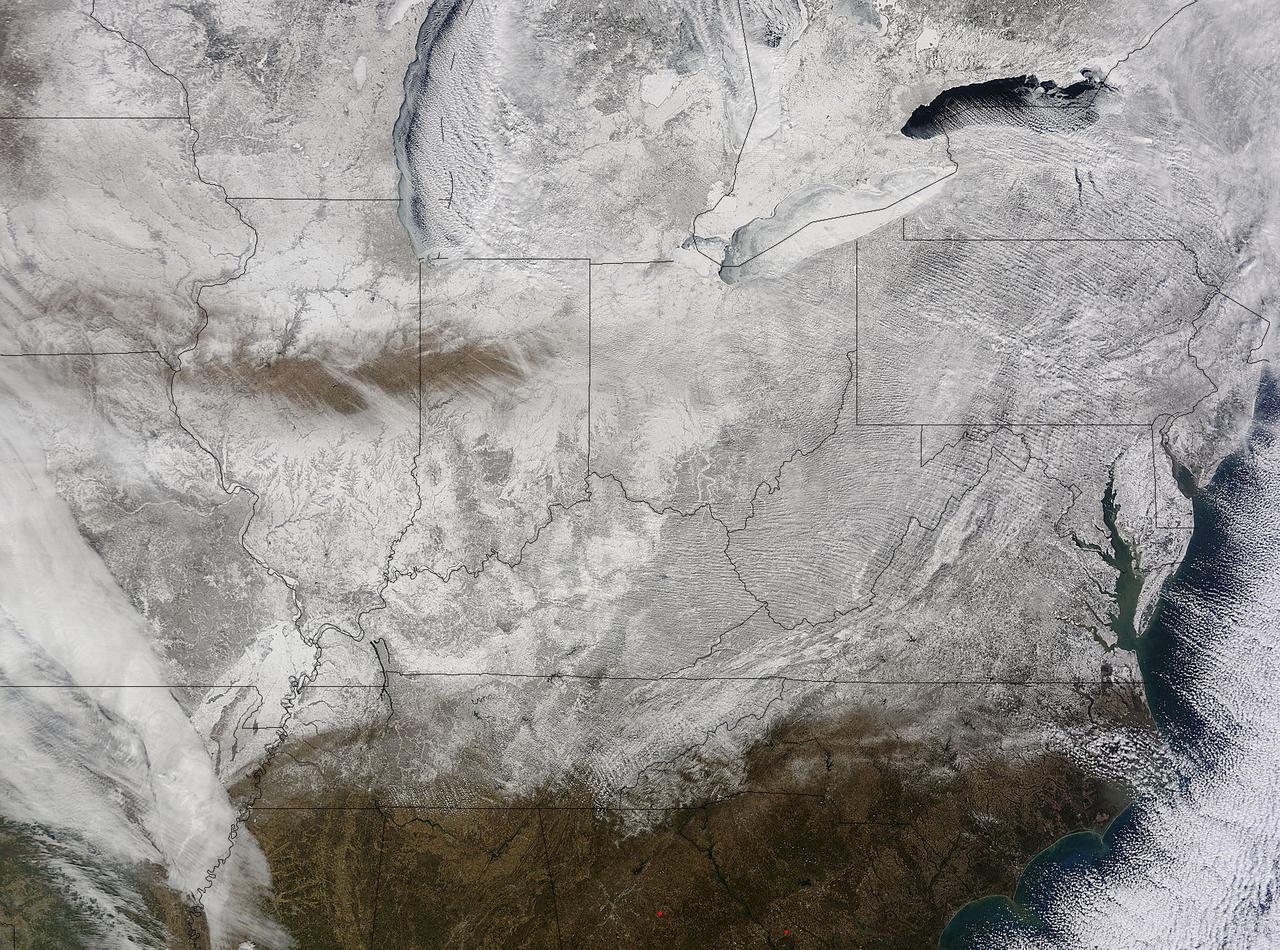 NASA's Terra satellite captured an image of the snow-covered eastern U.S. that looks like the states have been sitting in a freezer. In addition to the snow cover, Arctic and Siberian air masses have settled in over the Eastern U.S. triggering many record low temperatures in many states.  On Feb. 19 at 16:40 UTC (11:40 a.m. EST), the Moderate Resolution Imaging Spectroradiometer (MODIS) instrument that flies aboard NASA's Terra satellite captured a picture of the snowy landscape. The snow cover combined with the frosty air mass made the eastern U.S. feel like the inside of freezer. The MODIS image was created at NASA's Goddard Space Flight Center in Greenbelt, Maryland.  On the morning of Feb. 20, NOAA's Weather Prediction Center (WPC) noted, &quot;There were widespread subzero overnight lows Thursday night (Feb. 19) extending from Illinois to western Virginia, and numerous record lows were set. Bitterly-cold arctic air is setting numerous temperature records across the eastern U.S. and will keep temperatures well below normal on Friday (Feb. 20).&quot; In Baltimore, Maryland, a low temperature of 1F broke the record low for coldest morning recorded at the Thurgood Marshall Baltimore Washington-International Airport.  In Louisville, Kentucky, temperatures dropped to -6F, breaking the old record low of 0F, according to meteorologist Brian Goode of WAVE-TV.  Meanwhile, Richmond Kentucky bottomed out at a frigid -32F.   In North Carolina, a record low temperature was set at Charlotte where the overnight temperature bottomed out at 7F breaking the old record of 13F in 1896. In Asheville, temperatures dropped to just 4F breaking the old record of 10F in 1979. Temperature records for Asheville extend back to 1876.     Several records were also broken in Georgia, according to Matt Daniel, a meteorologist at WMAZ-TV, Macon Georgia, who cited data from the National Weather Service. Daniel said that Macon set a new record low when the temperature dropped to 18F, beating the previous record of 21F set in 1958. Athens broke a new record low, too dropping to 14F and beating the old record of 18F set in 1958/1928.  NOAA's NPC noted that &quot;Highs on Friday (Feb. 20) will struggle to get out of the teens from the Ohio Valley to the Mid-Atlantic region.  After Friday, temperatures are forecast to moderate and get closer to February averages as a storm system approaches from the west.&quot;  Image Credit: NASA Goddard MODIS Rapid Response Team  <b><a href="http://www.nasa.gov/audience/formedia/features/MP_Photo_Guidelines.html" rel="nofollow">NASA image use policy.</a></b>  <b><a href="http://www.nasa.gov/centers/goddard/home/index.html" rel="nofollow">NASA Goddard Space Flight Center</a></b> enables NASA’s mission through four scientific endeavors: Earth Science, Heliophysics, Solar System Exploration, and Astrophysics. Goddard plays a leading role in NASA’s accomplishments by contributing compelling scientific knowledge to advance the Agency’s mission. <b>Follow us on <a href="http://twitter.com/NASAGoddardPix" rel="nofollow">Twitter</a></b> <b>Like us on <a href="http://www.facebook.com/pages/Greenbelt-MD/NASA-Goddard/395013845897?ref=tsd" rel="nofollow">Facebook</a></b> <b>Find us on <a href="http://instagram.com/nasagoddard?vm=grid" rel="nofollow">Instagram</a></b> 