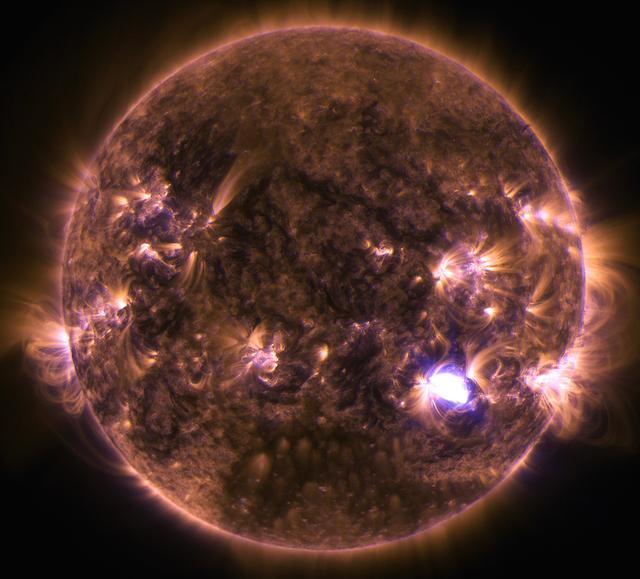 The sun emitted a solar flare on Dec. 4, 2014, seen as the flash of light in this image from NASA's Solar Dynamics Observatory. The image blends two wavelengths of extreme ultraviolet light – 131 and 171 Angstroms – which are typically colored in teal and gold, respectively. Read more: <a href="http://1.usa.gov/121n7PP" rel="nofollow">1.usa.gov/121n7PP</a> Image Credit: NASA/SDO