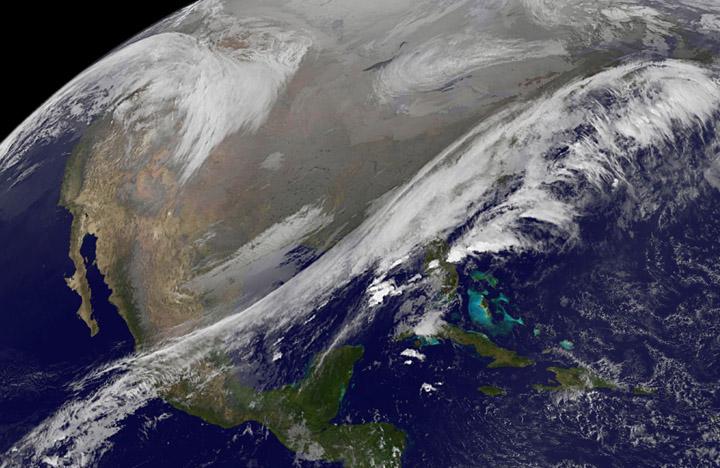 This NOAA's GOES satellite infrared image taken on Nov. 25 at 11:45 UTC (6:45 a.m. EST) shows two main weather systems over the U.S.  Credit: NASA/NOAA GOES Project  As the U.S. Thanksgiving holiday approaches this Thursday, November 27, NOAA's GOES-East and GOES-West satellites are keeping a weather eye out for storms that may affect early travelers. In an image from Nov. 25, the satellites show an active weather pattern is in place for travelers across the central and eastern U.S.  NOAA's GOES-East satellite provides visible and infrared images over the eastern U.S. and the Atlantic Ocean, while NOAA's GOES-West satellite covers the western U.S. and Pacific Ocean from its fixed orbit in space. Data from both satellites were combined at NASA's GOES Project to create a full view of the U.S. on Nov. 25 at 11:45 UTC (6:45 a.m. EST). The image shows clouds associated with cold front stretching from the Gulf of Mexico over northern Florida and along the U.S. East coast to eastern Canada. Clouds associated with another area of low pressure are in the northern Rockies and northwestern U.S.  To create the image, NASA/NOAA's GOES Project takes the cloud data from NOAA's GOES-East satellite and overlays it on a true-color image of land and ocean created by data from the Moderate Resolution Imaging Spectroradiometer, or MODIS, instrument that flies aboard NASA's Aqua and Terra satellites. Together, those data created the entire picture of the storm and show its movement. After the storm system passes, the snow on the ground becomes visible.  NOAA's National Weather Service Weather Prediction Center said &quot;a storm system will develop off the coast of the Carolinas early Wednesday (Nov. 25) and strengthen as it moves rapidly up the East Coast Wednesday into early Thursday (Nov. 26). Heavy snow is likely to begin in the central Appalachians early Wednesday morning, spreading northeast through the interior Mid-Atlantic into New England by Wednesday night. Winter Storm Watches are in effect for these areas.&quot;  For travelers in the western U.S., the Northern Rocky Mountains are expected to receive more snow from the north side of a stationary frontal boundary. South of the boundary rain showers will affect the lower valley. The National Weather Service calls for cold weather to continue in the northern Plains and Upper Midwest as a Canadian surface high pressure rules the weather. The U.S. Southwest will experience nice weather for mid-week.  In the Pacific Northwest, the National Weather Service noted that a warm front will bring rain, heavy at times, to the Cascades today and tonight. There will be a break in the heavier rains on Wednesday, then another period of heavy rain for the Cascades Wednesday night through Friday morning as a cold front slowly drags through the area.  NOAA's GOES satellites provide the kind of continuous monitoring necessary for intensive data analysis. Geostationary describes an orbit in which a satellite is always in the same position with respect to the rotating Earth. This allows GOES to hover continuously over one position on Earth's surface, appearing stationary. As a result, GOES provide a constant vigil for the atmospheric triggers for severe weather conditions such as tornadoes, flash floods, hail storms and hurricanes. 