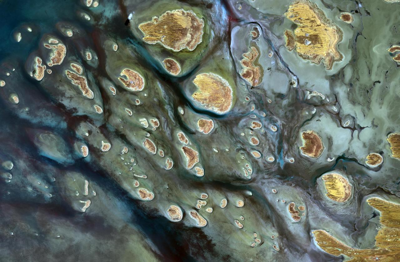 Lake Mackay is the largest of hundreds of ephemeral lakes scattered throughout Western Australia and the Northern Territory, and is the second largest lake in Australia. The darker areas indicate some form of desert vegetation or algae, moisture within the soils, and lowest elevations where water pools. The image was acquired on September 19, 2010 and covers an area of 27 x 41 km. With its 14 spectral bands from the visible to the thermal infrared wavelength region and its high spatial resolution of 15 to 90 meters (about 50 to 300 feet), ASTER images Earth to map and monitor the changing surface of our planet. ASTER is one of five Earth-observing instruments launched Dec. 18, 1999, on Terra. The instrument was built by Japan's Ministry of Economy, Trade and Industry. A joint U.S./Japan science team is responsible for validation and calibration of the instrument and data products. The broad spectral coverage and high spectral resolution of ASTER provides scientists in numerous disciplines with critical information for surface mapping and monitoring of dynamic conditions and temporal change. Example applications are: monitoring glacial advances and retreats; monitoring potentially active volcanoes; identifying crop stress; determining cloud morphology and physical properties; wetlands evaluation; thermal pollution monitoring; coral reef degradation; surface temperature mapping of soils and geology; and measuring surface heat balance. The U.S. science team is located at NASA's Jet Propulsion Laboratory, Pasadena, Calif. The Terra mission is part of NASA's Science Mission Directorate, Washington, D.C. More information about ASTER is available at <a href="http://asterweb.jpl.nasa.gov/" rel="nofollow">asterweb.jpl.nasa.gov/</a>. Image Credit: NASA/GSFC/METI/ERSDAC/JAROS, and U.S./Japan ASTER Science Team
