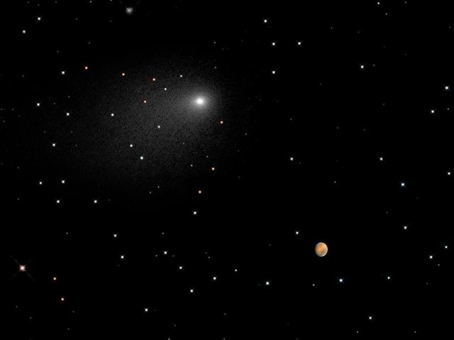 This composite NASA Hubble Space Telescope Image captures the positions of comet Siding Spring and Mars in a never-before-seen close passage of a comet by the Red Planet, which happened at 2:28 p.m. EDT October 19, 2014. The comet passed by Mars at approximately 87,000 miles (about one-third of the distance between Earth and the Moon). At that time, the comet and Mars were approximately 149 million miles from Earth.  The comet image shown here is a composite of Hubble exposures taken between Oct. 18, 8:06 a.m. EDT to Oct. 19, 11:17 p.m. EDT. Hubble took a separate photograph of Mars at 10:37 p.m. EDT on Oct. 18.  The Mars and comet images have been added together to create a single picture to illustrate the angular separation, or distance, between the comet and Mars at closest approach. The separation is approximately 1.5 arc minutes, or one-twentieth of the angular diameter of the full Moon. The background starfield in this composite image is synthesized from ground-based telescope data provided by the Palomar Digital Sky Survey, which has been reprocessed to approximate Hubble’s resolution. The solid icy comet nucleus is too small to be resolved in the Hubble picture. The comet’s bright coma, a diffuse cloud of dust enshrouding the nucleus, and a dusty tail, are clearly visible.  This is a composite image because a single exposure of the stellar background, comet Siding Spring, and Mars would be problematic. Mars is actually 10,000 times brighter than the comet, and so could not be properly exposed to show detail in the Red Planet. The comet and Mars were also moving with respect to each other and so could not be imaged simultaneously in one exposure without one of the objects being motion blurred. Hubble had to be programmed to track on the comet and Mars separately in two different observations.   The images were taken with Hubble’s Wide Field Camera 3.  Credit: NASA, ESA, PSI, JHU/APL, STScI/AURA  Credit: NASA, ESA, PSI, JHU/APL, STScI/AURA