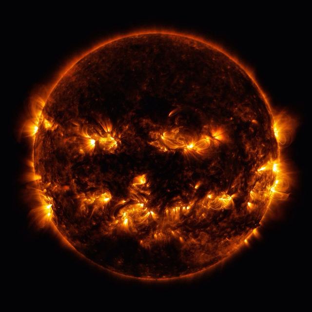 Active regions on the sun combined to look something like a jack-o-lantern’s face on Oct. 8, 2014. The active regions appear brighter because those are areas that emit more light and energy — markers of an intense and complex set of magnetic fields hovering in the sun’s atmosphere, the corona. This image blends together two sets of wavelengths at 171 and 193 Angstroms, typically colorized in gold and yellow, to create a particularly Halloween-like appearance.  Credit: NASA/Goddard/SDO  <b><a href="http://www.nasa.gov/audience/formedia/features/MP_Photo_Guidelines.html" rel="nofollow">NASA image use policy.</a></b>  <b><a href="http://www.nasa.gov/centers/goddard/home/index.html" rel="nofollow">NASA Goddard Space Flight Center</a></b> enables NASA’s mission through four scientific endeavors: Earth Science, Heliophysics, Solar System Exploration, and Astrophysics. Goddard plays a leading role in NASA’s accomplishments by contributing compelling scientific knowledge to advance the Agency’s mission. <b>Follow us on <a href="http://twitter.com/NASAGoddardPix" rel="nofollow">Twitter</a></b> <b>Like us on <a href="http://www.facebook.com/pages/Greenbelt-MD/NASA-Goddard/395013845897?ref=tsd" rel="nofollow">Facebook</a></b> <b>Find us on <a href="http://instagram.com/nasagoddard?vm=grid" rel="nofollow">Instagram</a></b>