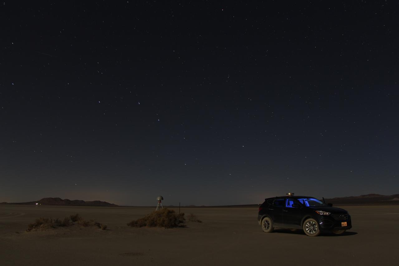 At first glance a dry lake bed in the southern California desert seems like the last place to prepare to study ice. But on Oct. 2, 2014, NASA’s Operation IceBridge carried out a ground-based GPS survey of the El Mirage lake bed in California’s Mojave Desert. Members of the IceBridge team are currently at NASA’s Armstrong Flight Research Center, preparing instruments aboard the DC-8 research aircraft for flights over Antarctica. Part of this preparation involves test flights over the desert, where researchers verify their instruments are working properly. El Mirage serves as a prime location for testing the mission’s laser altimeter, the Airborne Topographic Mapper, because the lake bed has a flat surface and reflects light similarly to snow and ice. This photo, taken shortly after the survey, shows the GPS-equipped survey vehicle and a stationary GPS station (left of the vehicle) on the lake bed with the constellation Ursa Major in the background. By driving the vehicle in parallel back and forth lines over a predefined area and comparing those GPS elevation readings with measurements from the stationary GPS, researchers are able to build an elevation map that will be used to precisely calibrate the laser altimeter for ice measurements. Credit: NASA/John Sonntag Operation IceBridge is scheduled to begin research flights over Antarctica on Oct. 15, 2014. The mission will be based out of Punta Arenas, Chile, until Nov. 23. For more information about IceBridge, visit: <a href="http://www.nasa.gov/icebridge" rel="nofollow">www.nasa.gov/icebridge</a> <b><a href="http://www.nasa.gov/audience/formedia/features/MP_Photo_Guidelines.html" rel="nofollow">NASA image use policy.</a></b> <b><a href="http://www.nasa.gov/centers/goddard/home/index.html" rel="nofollow">NASA Goddard Space Flight Center</a></b> enables NASA’s mission through four scientific endeavors: Earth Science, Heliophysics, Solar System Exploration, and Astrophysics. Goddard plays a leading role in NASA’s accomplishments by contributing compelling scientific knowledge to advance the Agency’s mission. <b>Follow us on <a href="http://twitter.com/NASAGoddardPix" rel="nofollow">Twitter</a></b> <b>Like us on <a href="http://www.facebook.com/pages/Greenbelt-MD/NASA-Goddard/395013845897?ref=tsd" rel="nofollow">Facebook</a></b> <b>Find us on <a href="http://instagram.com/nasagoddard?vm=grid" rel="nofollow">Instagram</a></b>