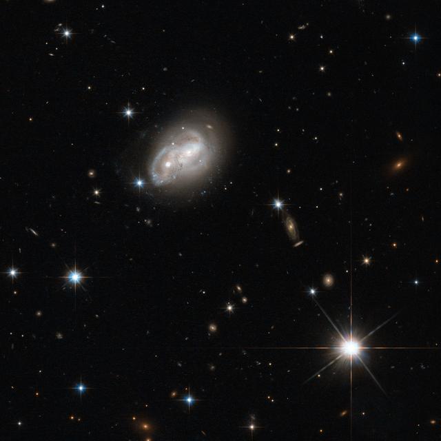 NASA image: Hubble Eyes Galaxy as it Gets a Cosmic Hair Ruffling