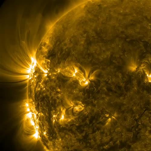 Two active regions with their intense magnetic fields produced towering arches and spiraling coils of solar loops above them (June 29 - July 1, 2014) as they rotated into view. When viewed in extreme ultraviolet light, magnetic field lines are revealed by charged particles that travel along them. These active regions appear as dark sunspots when viewed in filtered light. Note the small blast in the upper of the two major active regions, followed by more coils of loops as the region reorganizes itself. The still was taken on June 30 at 10:33 UT.   Credit: NASA/Solar Dynamics Observatory  Two active regions with their intense magnetic fields produced towering arches and spiraling coils of solar loops above them (June 29 - July 1, 2014) as they rotated into view. When viewed in extreme ultraviolet light, magnetic field lines are revealed by charged particles that travel along them. These active regions appear as dark sunspots when viewed in filtered light. Note the small blast in the upper of the two major active regions, followed by more coils of loops as the region reorganizes itself. The still was taken on June 30 at 10:33 UT. Credit: Solar Dynamics Observatory/NASA.