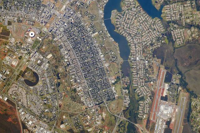 Brazil’s national football stadium, the Estado Nacíonal, lies near the heart of the capital city of Brasília. The roof appears as a brilliant white ring in this photograph taken from the International Space Station. The stadium is one of Brasília’s largest buildings. Renovation began in 2010, and it is now the second most expensive stadium in the world after Wembley Stadium in London.  To accommodate World Cup fans visiting from all over the world, renovations were made to nearly all modes of transportation—particularly airports—in Brasília and other host cities. Brasília’s international airport is visible at lower right, on the far side of Lake Paranoá. (Note that the image is rotated so that north is to the left.)  Brasília is widely known for its modern building designs and city layout. Astronauts have the best view of the city’s well-known “swept wing” city layout, which takes the form of a flying bird that is expressed in the curves of the boulevards (image left). The stadium occupies the city center, between the wings.  Credit: ISS  Read more/high res: <a href="http://earthobservatory.nasa.gov/NaturalHazards/view.php?id=83866&amp;src=nha" rel="nofollow">earthobservatory.nasa.gov/NaturalHazards/view.php?id=8386...</a>  Credit: <b><a href="http://www.earthobservatory.nasa.gov/" rel="nofollow"> NASA Earth Observatory</a></b>  <b><a href="http://www.nasa.gov/audience/formedia/features/MP_Photo_Guidelines.html" rel="nofollow">NASA image use policy.</a></b>  <b><a href="http://www.nasa.gov/centers/goddard/home/index.html" rel="nofollow">NASA Goddard Space Flight Center</a></b> enables NASA’s mission through four scientific endeavors: Earth Science, Heliophysics, Solar System Exploration, and Astrophysics. Goddard plays a leading role in NASA’s accomplishments by contributing compelling scientific knowledge to advance the Agency’s mission.  <b>Follow us on <a href="http://twitter.com/NASAGoddardPix" rel="nofollow">Twitter</a></b>  <b>Like us on <a href="http://www.facebook.com/pages/Greenbelt-MD/NASA-Goddard/395013845897?ref=tsd" rel="nofollow">Facebook</a></b>  <b>Find us on <a href="http://instagram.com/nasagoddard?vm=grid" rel="nofollow">Instagram</a></b> 