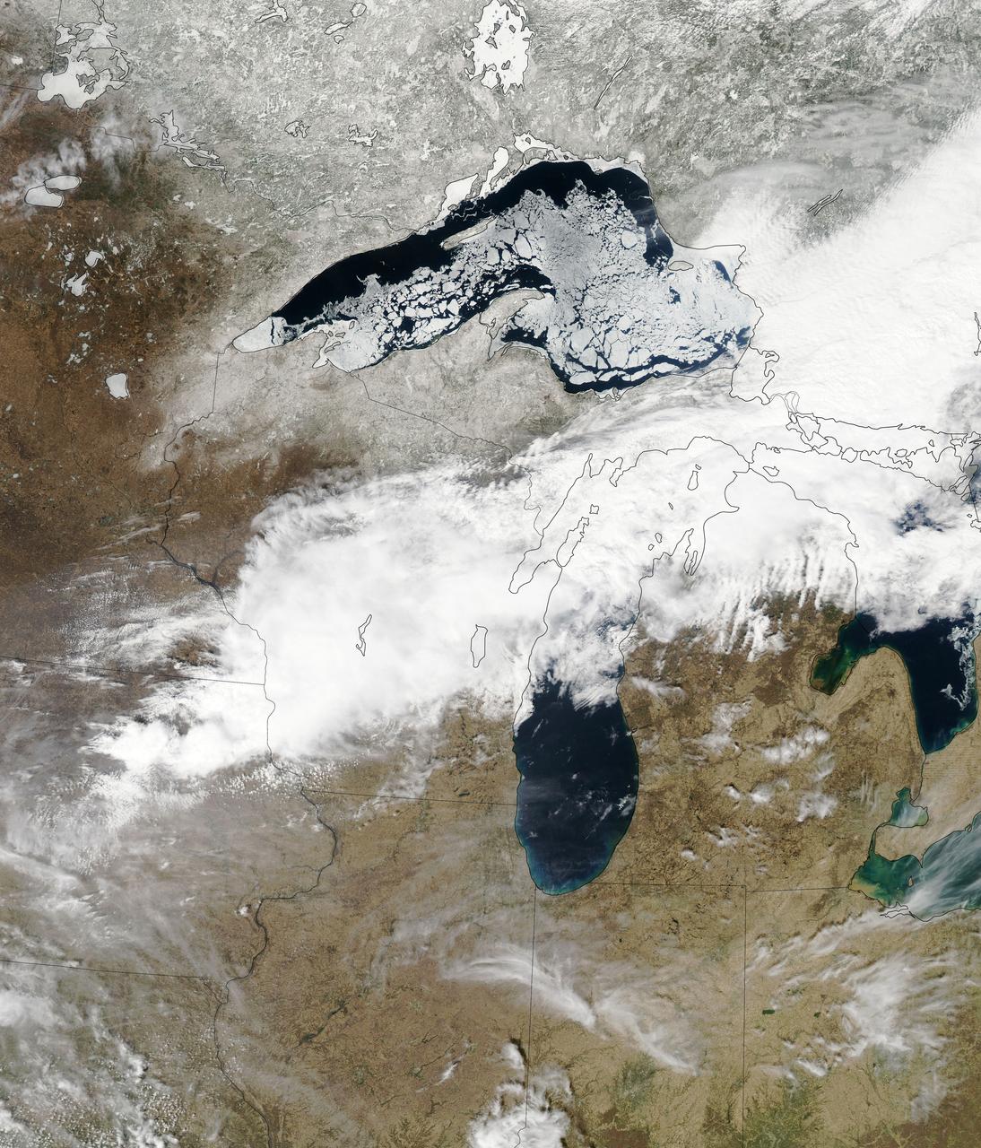 Though North America is a full month into astronomical spring, the Great Lakes have been slow to give up on winter. As of April 22, 2014, the Great Lakes were 33.9 percent ice covered. The lake they call Superior dominated the pack. In the early afternoon on April 20, 2014, the Moderate Resolution Imaging Spectroradiometer (MODIS) on NASA’s Aqua satellite captured this natural-color image of Lake Superior, which straddles the United States–Canada border. At the time Aqua passed over, the lake was 63.5 percent ice covered, according to the NOAA Great Lakes Environmental Research Lab (GLERL). Averaged across Lake Superior, ice was 22.6 centimeters (8.9 inches) thick; it was as much as twice that thickness in some locations. GLERL researcher George Leshkevich affirmed that ice cover this spring is significantly above normal. For comparison, Lake Superior had 3.6 percent ice cover on April 20, 2013; in 2012, ice was completely gone by April 12. In the last winter that ice cover grew so thick on Lake Superior (2009), it reached 93.7 percent on March 2 but was down to 6.7 percent by April 21. Average water temperatures on all of the Great Lakes have been rising over the past 30 to 40 years and ice cover has generally been shrinking. (Lake Superior ice was down about 79 percent since the 1970s.) But chilled by persistent polar air masses throughout the 2013-14 winter, ice cover reached 88.4 percent on February 13 and 92.2 percent on March 6, 2014, the second highest level in four decades of record-keeping. Air temperatures in the Great Lakes region were well below normal for March, and the cool pattern is being reinforced along the coasts because the water is absorbing less sunlight and warming less than in typical spring conditions. The graph below, based on data from Environment Canada, shows the 2014 conditions for all of the Great Lakes in mid-April compared to the past 33 years.  Lake Superior ice cover got as high as 95.3 percent on March 19. By April 22, it was reported at 59.9 percent; Lake Huron was nearly 30.4 percent. News outlets noted that as many as 70 ships have been backed up in Lakes Michigan, Huron, and Erie, waiting for passage into ports on Lake Superior. The U.S. Coast Guard has been grouping ships together into small convoys after they pass through locks at Sault Ste. Marie, in order to maximize ice-breaking efficiency and to protect ships from damage. Superior is the world’s largest freshwater lake by area (82,100 square kilometers or 31,700 square miles) and the third largest by volume. The waters average 147 meters (483 feet) in depth, and the basin is believed to hold about 10 percent of the world’s liquid fresh water.  NASA image courtesy Jeff Schmaltz LANCE/EOSDIS MODIS Rapid Response Team, GSFC. Caption by Mike Carlowicz.  Read more: <a href="http://earthobservatory.nasa.gov/IOTD/view.php?id=83541&amp;eocn=home&amp;eoci=iotd_title" rel="nofollow">earthobservatory.nasa.gov/IOTD/view.php?id=83541&amp;eocn...</a>  Credit: <b><a href="http://www.earthobservatory.nasa.gov/" rel="nofollow"> NASA Earth Observatory</a></b>  <b><a href="http://www.nasa.gov/audience/formedia/features/MP_Photo_Guidelines.html" rel="nofollow">NASA image use policy.</a></b>  <b><a href="http://www.nasa.gov/centers/goddard/home/index.html" rel="nofollow">NASA Goddard Space Flight Center</a></b> enables NASA’s mission through four scientific endeavors: Earth Science, Heliophysics, Solar System Exploration, and Astrophysics. Goddard plays a leading role in NASA’s accomplishments by contributing compelling scientific knowledge to advance the Agency’s mission.  <b>Follow us on <a href="http://twitter.com/NASAGoddardPix" rel="nofollow">Twitter</a></b>  <b>Like us on <a href="http://www.facebook.com/pages/Greenbelt-MD/NASA-Goddard/395013845897?ref=tsd" rel="nofollow">Facebook</a></b>  <b>Find us on <a href="http://instagram.com/nasagoddard?vm=grid" rel="nofollow">Instagram</a></b>