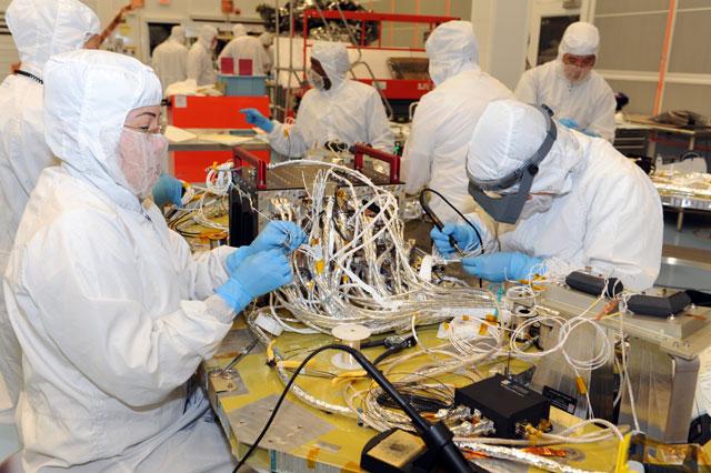 Electrical technicians work diligently to build the connector harnessing for the Command and Data Handling (C&amp;DH) unit, (black box with two red handles) that is installed on spacecraft Deck for MMS #4.  Learn more about MMS at <a href="http://www.nasa.gov/mms" rel="nofollow">www.nasa.gov/mms</a>   Credit NASA/Goddard  The Magnetospheric Multiscale, or MMS, will study how the sun and the Earth's magnetic fields connect and disconnect, an explosive process that can accelerate particles through space to nearly the speed of light. This process is called magnetic reconnection and can occur throughout all space.   <b><a href="http://www.nasa.gov/audience/formedia/features/MP_Photo_Guidelines.html" rel="nofollow">NASA image use policy.</a></b>  <b><a href="http://www.nasa.gov/centers/goddard/home/index.html" rel="nofollow">NASA Goddard Space Flight Center</a></b> enables NASA’s mission through four scientific endeavors: Earth Science, Heliophysics, Solar System Exploration, and Astrophysics. Goddard plays a leading role in NASA’s accomplishments by contributing compelling scientific knowledge to advance the Agency’s mission.  <b>Follow us on <a href="http://twitter.com/NASAGoddardPix" rel="nofollow">Twitter</a></b>  <b>Like us on <a href="http://www.facebook.com/pages/Greenbelt-MD/NASA-Goddard/395013845897?ref=tsd" rel="nofollow">Facebook</a></b>  <b>Find us on <a href="http://instagram.com/nasagoddard?vm=grid" rel="nofollow">Instagram</a></b>