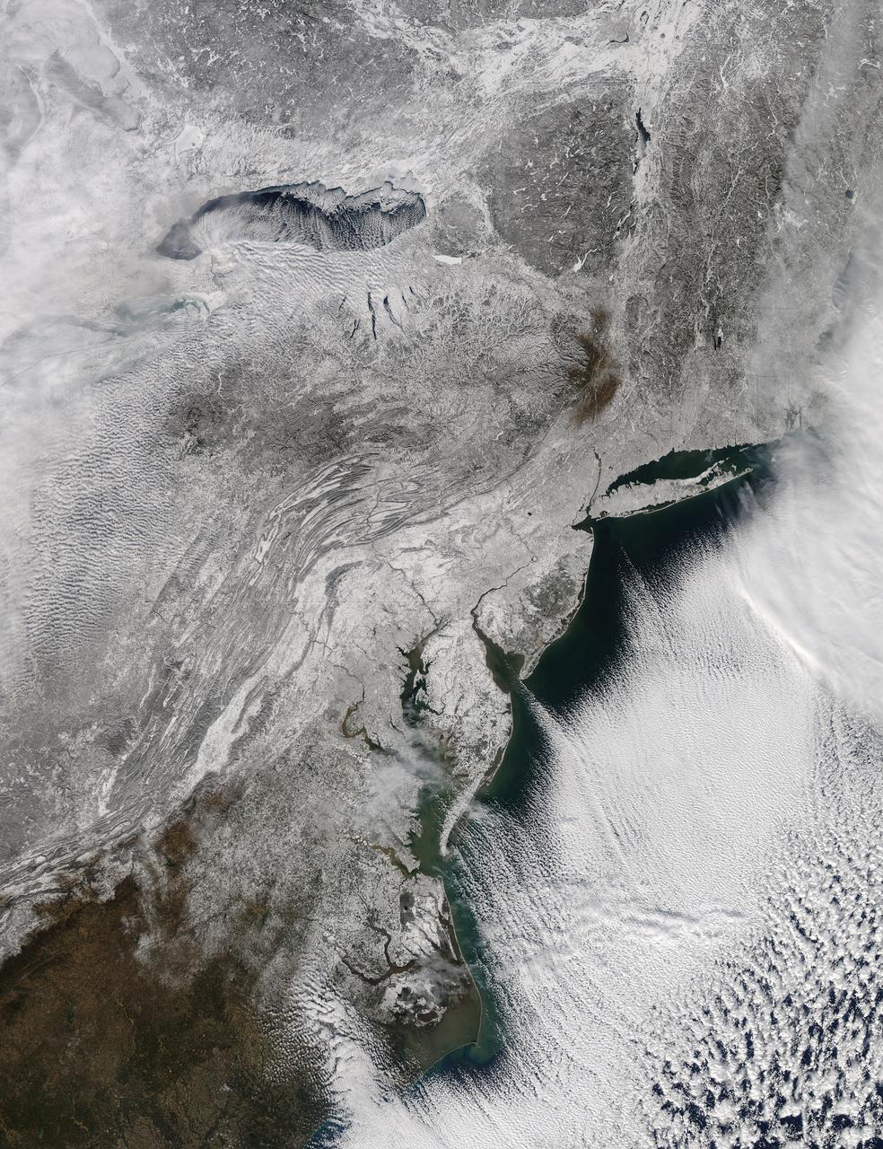 The storm system that moved through the northeastern U.S. dropped large snowfall totals up to a foot in southern New England to a couple of inches in Virginia. On January 22, 2014, the day after the event, the Moderate Resolution Imaging Spectroradiometer instrument that flies aboard NASA's Aqua satellite captured this image of the snowfall at 18:10 UTC/1:10 p.m. EST.  In the image, snowfall covers the ground in all six New England states, New York, Pennsylvania, New Jersey, Delaware, Maryland, West Virginia, Ohio, Virginia, Washington, D.C.  and  North Carolina.   Image Credit: NASA Goddard MODIS Rapid Response Team Text: Rob Gutro, NASA Goddard Space Flight Center   <b><a href="http://www.nasa.gov/audience/formedia/features/MP_Photo_Guidelines.html" rel="nofollow">NASA image use policy.</a></b>  <b><a href="http://www.nasa.gov/centers/goddard/home/index.html" rel="nofollow">NASA Goddard Space Flight Center</a></b> enables NASA’s mission through four scientific endeavors: Earth Science, Heliophysics, Solar System Exploration, and Astrophysics. Goddard plays a leading role in NASA’s accomplishments by contributing compelling scientific knowledge to advance the Agency’s mission.  <b>Follow us on <a href="http://twitter.com/NASAGoddardPix" rel="nofollow">Twitter</a></b>  <b>Like us on <a href="http://www.facebook.com/pages/Greenbelt-MD/NASA-Goddard/395013845897?ref=tsd" rel="nofollow">Facebook</a></b>  <b>Find us on <a href="http://instagram.com/nasagoddard?vm=grid" rel="nofollow">Instagram</a></b>