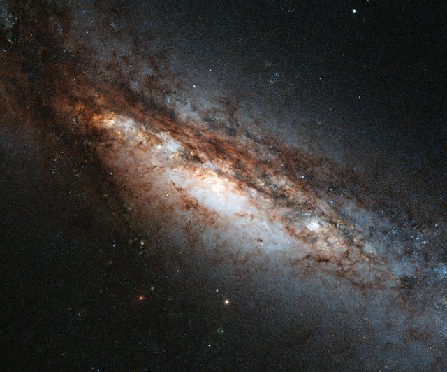 This new Hubble image shows a peculiar galaxy known as NGC 660, located around 45 million light-years away from us. NGC 660 is classified as a "polar ring galaxy," meaning that it has a belt of gas and stars around its center that it ripped from a near neighbor during a clash about one billion years ago.The first polar ring galaxy was observed in 1978 and only around a dozen more have been discovered since then, making them something of a cosmic rarity. Unfortunately, NGC 660’s polar ring cannot be seen in this image, but the image has plenty of other features that make it of interest to astronomers – its central bulge is strangely off-kilter and, perhaps more intriguingly, it is thought to harbor exceptionally large amounts of dark matter. In addition, in late 2012 astronomers observed a massive outburst emanating from NGC 660 that was around ten times as bright as a supernova explosion. This burst was thought to be caused by a massive jet shooting out of the supermassive black hole at the center of the galaxy. Credit: Hubble/NASA/European Space Agency <b><a href="http://www.nasa.gov/audience/formedia/features/MP_Photo_Guidelines.html" rel="nofollow">NASA image use policy.</a></b> <b><a href="http://www.nasa.gov/centers/goddard/home/index.html" rel="nofollow">NASA Goddard Space Flight Center</a></b> enables NASA’s mission through four scientific endeavors: Earth Science, Heliophysics, Solar System Exploration, and Astrophysics. Goddard plays a leading role in NASA’s accomplishments by contributing compelling scientific knowledge to advance the Agency’s mission. <b>Follow us on <a href="http://twitter.com/NASA_GoddardPix" rel="nofollow">Twitter</a></b> <b>Like us on <a href="http://www.facebook.com/pages/Greenbelt-MD/NASA-Goddard/395013845897?ref=tsd" rel="nofollow">Facebook</a></b> <b>Find us on <a href="http://instagram.com/nasagoddard?vm=grid" rel="nofollow">Instagram</a></b>
