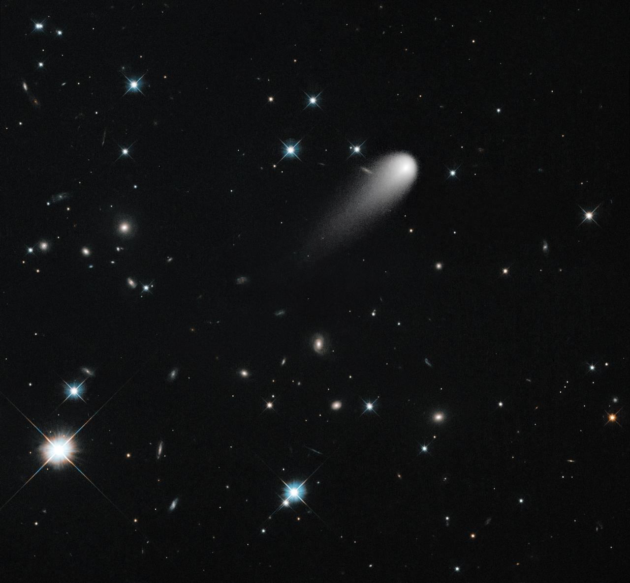 On April 30, NASA's Hubble Space Telescope observed Comet ISON again. The comet is in the upper middle, showing the long tail.  Various galaxies and stars appear behind it.  In this image, Hubble trained its telescope on the stars instead of following the comet.  The result is that the comet appears fuzzier, but the stars and galaxies are more detailed and precise. These dimmer features don't pop out if the camera is moving, following along with ISON.  To see them, you really need to dwell in one place until they emerge from the noise.  Credit: NASA/ESA/STScI/AURA  --------  More details on Comet ISON:  Comet ISON began its trip from the Oort cloud region of our solar system and is now travelling toward the sun. The comet will reach its closest approach to the sun on Thanksgiving Day -- 28 Nov 2013 -- skimming just 730,000 miles above the sun's surface. If it comes around the sun without breaking up, the comet will be visible in the Northern Hemisphere with the naked eye, and from what we see now, ISON is predicted to be a particularly bright and beautiful comet.  Catalogued as C/2012 S1, Comet ISON was first spotted 585 million miles away in September 2012. This is ISON's very first trip around the sun, which means it is still made of pristine matter from the earliest days of the solar system’s formation, its top layers never having been lost by a trip near the sun. Comet ISON is, like all comets, a dirty snowball made up of dust and frozen gases like water, ammonia, methane and carbon dioxide -- some of the fundamental building blocks that scientists believe led to the formation of the planets 4.5 billion years ago.   NASA has been using a vast fleet of spacecraft, instruments, and space- and Earth-based telescope, in order to learn more about this time capsule from when the solar system first formed.   The journey along the way for such a sun-grazing comet can be dangerous. A giant ejection of solar material from the sun could rip its tail off. Before it reaches Mars -- at some 230 million miles away from the sun -- the radiation of the sun begins to boil its water, the first step toward breaking apart. And, if it survives all this, the intense radiation and pressure as it flies near the surface of the sun could destroy it altogether.   This collection of images show ISON throughout that journey, as scientists watched to see whether the comet would break up or remain intact.    The comet reaches its closest approach to the sun on Thanksgiving Day -- Nov. 28, 2013 -- skimming just 730,000 miles above the sun’s surface. If it comes around the sun without breaking up, the comet will be visible in the Northern Hemisphere with the naked eye, and from what we see now, ISON is predicted to be a particularly bright and beautiful comet.   ISON stands for International Scientific Optical Network, a group of observatories in ten countries who have organized to detect, monitor, and track objects in space. ISON is managed by the Keldysh Institute of Applied Mathematics, part of the Russian Academy of Sciences.  <b><a href="http://www.nasa.gov/audience/formedia/features/MP_Photo_Guidelines.html" rel="nofollow">NASA image use policy.</a></b>  <b><a href="http://www.nasa.gov/centers/goddard/home/index.html" rel="nofollow">NASA Goddard Space Flight Center</a></b> enables NASA’s mission through four scientific endeavors: Earth Science, Heliophysics, Solar System Exploration, and Astrophysics. Goddard plays a leading role in NASA’s accomplishments by contributing compelling scientific knowledge to advance the Agency’s mission.  <b>Follow us on <a href="http://twitter.com/NASA_GoddardPix" rel="nofollow">Twitter</a></b>  <b>Like us on <a href="http://www.facebook.com/pages/Greenbelt-MD/NASA-Goddard/395013845897?ref=tsd" rel="nofollow">Facebook</a></b>  <b>Find us on <a href="http://instagram.com/nasagoddard?vm=grid" rel="nofollow">Instagram</a></b>