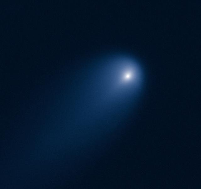 This NASA Hubble Space Telescope image of Comet (C/2012 S1) ISON was photographed on April 10, 2013, when the comet was slightly closer than Jupiter's orbit at a distance of 394 million miles from Earth.  Even at that great distance the comet is already active as sunlight warms the surface and causes frozen volatiles to boil off. Astronomers used such early images to try to measure the size of the nucleus, in order to predict whether the comet would stay intact when it slingshots around the sun -- at 700,000 miles above the sun's surface  -- on Nov. 28, 2013.  The comet's dusty coma, or head of the comet, is approximately 3,100 miles across, or 1.2 times the width of Australia. A dust tail extends more than 57,000 miles, far beyond Hubble's field of view.  This image was taken in visible light. The blue false color was added to bring out details in the comet structure.  Credit: NASA/ ESA/STScI/AURA   --------  More details on Comet ISON:  Comet ISON began its trip from the Oort cloud region of our solar system and is now travelling toward the sun. The comet will reach its closest approach to the sun on Thanksgiving Day -- 28 Nov 2013 -- skimming just 730,000 miles above the sun's surface. If it comes around the sun without breaking up, the comet will be visible in the Northern Hemisphere with the naked eye, and from what we see now, ISON is predicted to be a particularly bright and beautiful comet.  Catalogued as C/2012 S1, Comet ISON was first spotted 585 million miles away in September 2012. This is ISON's very first trip around the sun, which means it is still made of pristine matter from the earliest days of the solar system’s formation, its top layers never having been lost by a trip near the sun. Comet ISON is, like all comets, a dirty snowball made up of dust and frozen gases like water, ammonia, methane and carbon dioxide -- some of the fundamental building blocks that scientists believe led to the formation of the planets 4.5 billion years ago.   NASA has been using a vast fleet of spacecraft, instruments, and space- and Earth-based telescope, in order to learn more about this time capsule from when the solar system first formed.   The journey along the way for such a sun-grazing comet can be dangerous. A giant ejection of solar material from the sun could rip its tail off. Before it reaches Mars -- at some 230 million miles away from the sun -- the radiation of the sun begins to boil its water, the first step toward breaking apart. And, if it survives all this, the intense radiation and pressure as it flies near the surface of the sun could destroy it altogether.   This collection of images show ISON throughout that journey, as scientists watched to see whether the comet would break up or remain intact.    The comet reaches its closest approach to the sun on Thanksgiving Day -- Nov. 28, 2013 -- skimming just 730,000 miles above the sun’s surface. If it comes around the sun without breaking up, the comet will be visible in the Northern Hemisphere with the naked eye, and from what we see now, ISON is predicted to be a particularly bright and beautiful comet.   ISON stands for International Scientific Optical Network, a group of observatories in ten countries who have organized to detect, monitor, and track objects in space. ISON is managed by the Keldysh Institute of Applied Mathematics, part of the Russian Academy of Sciences.  <b><a href="http://www.nasa.gov/audience/formedia/features/MP_Photo_Guidelines.html" rel="nofollow">NASA image use policy.</a></b>  <b><a href="http://www.nasa.gov/centers/goddard/home/index.html" rel="nofollow">NASA Goddard Space Flight Center</a></b> enables NASA’s mission through four scientific endeavors: Earth Science, Heliophysics, Solar System Exploration, and Astrophysics. Goddard plays a leading role in NASA’s accomplishments by contributing compelling scientific knowledge to advance the Agency’s mission.  <b>Follow us on <a href="http://twitter.com/NASA_GoddardPix" rel="nofollow">Twitter</a></b>  <b>Like us on &lt;a href=&quot;http://www.facebook.com/pages/Greenbelt-MD/NASA-Godd</b>