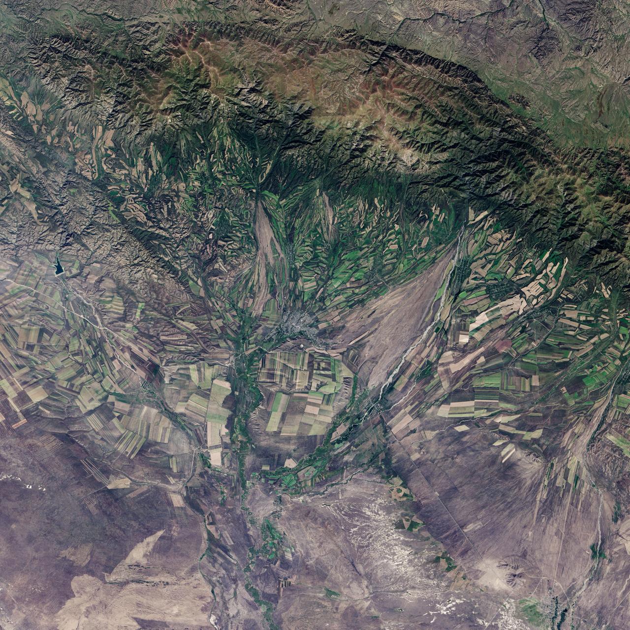 September 22, the autumnal equinox, marks the beginning of fall in the Northern Hemisphere, but the fall harvest begins early in the harsh continental climate of eastern Kazakhstan. By September 9, 2013, when the Operational Land Imager (OLI) on the Landsat 8 satellite acquired this image, several fields were already harvested and bare. Others were dark green with pasture grasses or ripening crops. The fields fill the contours of the land, running long and narrow down mountain valleys and spreading in large squares over the plains.  Agriculture is an important segment of the economy in Kazakhstan: the country’s dry climate is ideal for producing high quality wheat for export. However, 61 percent of the country’s agricultural land is pasture for livestock. The area shown in this image, far eastern Kazakhstan near the Chinese border, is a minor wheat-growing region and may also produce sunflowers, barley, and other food crops.  An artifact of Soviet-era collective farms, most of the farms in Kazakhstan are large, covering more than 5,000 hectares (12,500 acres). Some of the larger fields in the image reflect the big business side of agriculture. However, family farms and small agriculture businesses account for 35 percent of the country’s agricultural production, and some of these are visible as well, particularly in the uneven hills and mountains.  Nearly all agriculture in Kazakhstan is rain fed. Farmers in this region have designed their fields to take advantage of rain flowing down hills, allowing the natural shape of the land to channel water to crops. The effect is a mosaic of green and tan with tones matching the natural vegetation in the mountains to the north.  NASA Earth Observatory image by Jesse Allen using Landsat data from the U.S. Geological Survey. Caption by Holli Riebeek.  Instrument: Landsat 8 - OLI  More info: <a href="http://1.usa.gov/16IZ047" rel="nofollow">1.usa.gov/16IZ047</a>  <b><a href="http://www.nasa.gov/audience/formedia/features/MP_Photo_Guidelines.html" rel="nofollow">NASA image use policy.</a></b>  <b><a href="http://www.nasa.gov/centers/goddard/home/index.html" rel="nofollow">NASA Goddard Space Flight Center</a></b> enables NASA’s mission through four scientific endeavors: Earth Science, Heliophysics, Solar System Exploration, and Astrophysics. Goddard plays a leading role in NASA’s accomplishments by contributing compelling scientific knowledge to advance the Agency’s mission.  <b>Follow us on <a href="http://twitter.com/NASA_GoddardPix" rel="nofollow">Twitter</a></b>  <b>Like us on <a href="http://www.facebook.com/pages/Greenbelt-MD/NASA-Goddard/395013845897?ref=tsd" rel="nofollow">Facebook</a></b>  <b>Find us on <a href="http://instagram.com/nasagoddard?vm=grid" rel="nofollow">Instagram</a></b>