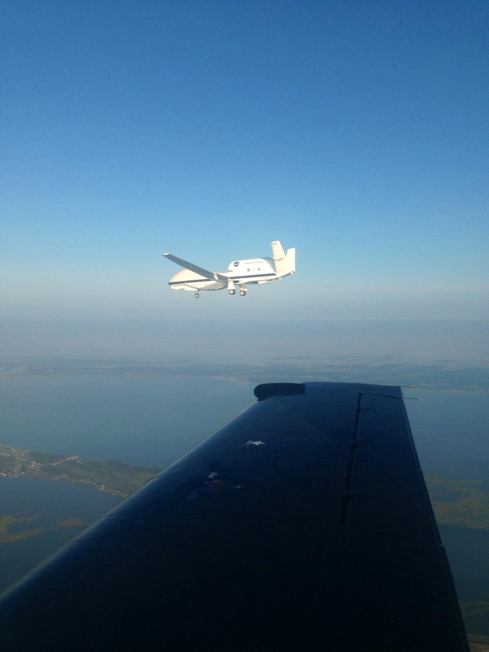 The NASA Wallops T-34 chase aircraft intercepted Global Hawk 872 on its descent to runway 28 at NASA's Wallops Flight Facility in Wallops Island, Va. This photo of the Global Hawk was taken from the chase plane after finishing its third science flight. For more information about NASA's HS3 mission, visit: <a href="http://www.nasa.gov/HS3" rel="nofollow">www.nasa.gov/HS3</a> Credit: NASA/ Brea Reeves <b><a href="http://www.nasa.gov/audience/formedia/features/MP_Photo_Guidelines.html" rel="nofollow">NASA image use policy.</a></b> <b><a href="http://www.nasa.gov/centers/goddard/home/index.html" rel="nofollow">NASA Goddard Space Flight Center</a></b> enables NASA’s mission through four scientific endeavors: Earth Science, Heliophysics, Solar System Exploration, and Astrophysics. Goddard plays a leading role in NASA’s accomplishments by contributing compelling scientific knowledge to advance the Agency’s mission. <b>Follow us on <a href="http://twitter.com/NASA_GoddardPix" rel="nofollow">Twitter</a></b> <b>Like us on <a href="http://www.facebook.com/pages/Greenbelt-MD/NASA-Goddard/395013845897?ref=tsd" rel="nofollow">Facebook</a></b> <b>Find us on <a href="http://instagram.com/nasagoddard?vm=grid" rel="nofollow">Instagram</a></b>