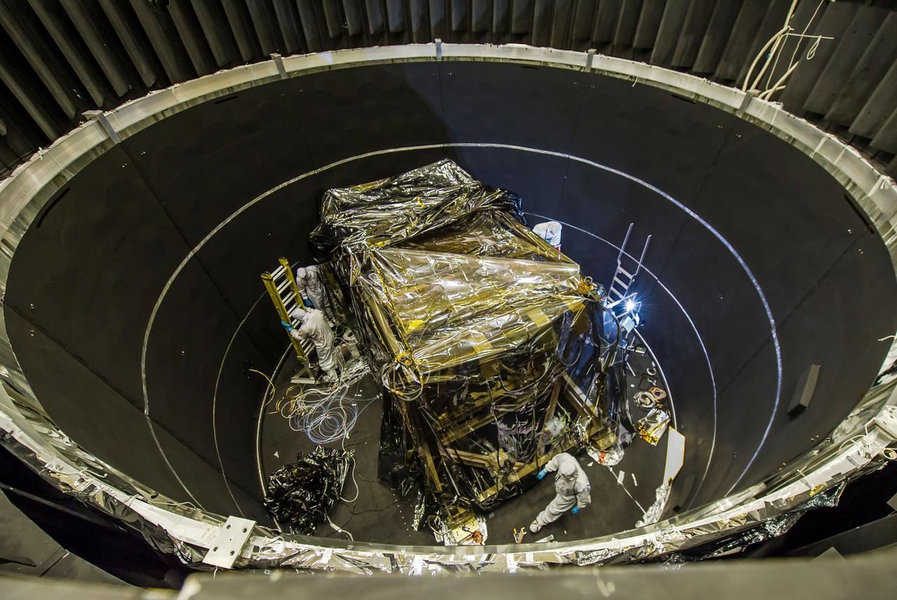 Engineers work with the Integrated Science Instrument Module for the James Webb Space Telescope inside the thermal vacuum chamber at NASA's Goddard Space Flight Center in Greenbelt, Md. The ISIM and the ISIM System Integration Fixture that holds the ISIM Electronics Compartment was recently lifted inside the chamber for its first thermal vacuum test. In this image one of the ISIM's many protective blanket layers is pulled back. The blankets will be removed during testing.  Image credit: NASA/Chris Gunn  <b><a href="http://www.nasa.gov/audience/formedia/features/MP_Photo_Guidelines.html" rel="nofollow">NASA image use policy.</a></b>  <b><a href="http://www.nasa.gov/centers/goddard/home/index.html" rel="nofollow">NASA Goddard Space Flight Center</a></b> enables NASA’s mission through four scientific endeavors: Earth Science, Heliophysics, Solar System Exploration, and Astrophysics. Goddard plays a leading role in NASA’s accomplishments by contributing compelling scientific knowledge to advance the Agency’s mission.  <b>Follow us on <a href="http://twitter.com/NASA_GoddardPix" rel="nofollow">Twitter</a></b>  <b>Like us on <a href="http://www.facebook.com/pages/Greenbelt-MD/NASA-Goddard/395013845897?ref=tsd" rel="nofollow">Facebook</a></b>  <b>Find us on <a href="http://instagram.com/nasagoddard?vm=grid" rel="nofollow">Instagram</a></b>