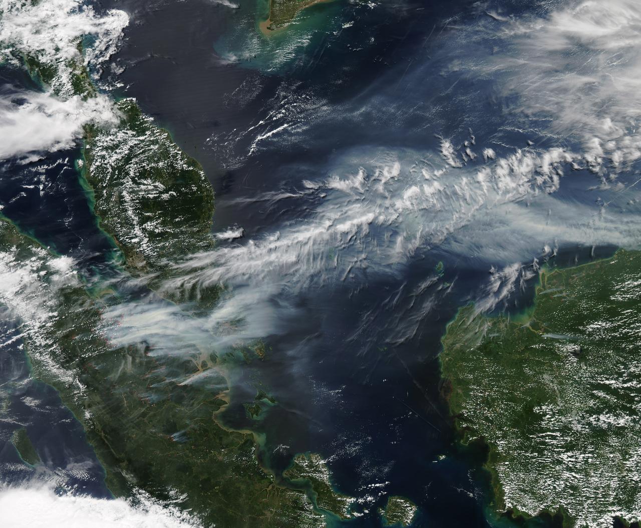On June 19, 2013, NASA’s Aqua satellite captured a striking image of smoke billowing from illegal wildfires on the Indonesian island of Sumatra. The smoke blew east toward southern Malaysia and Singapore, and news media reported that thick clouds of haze had descended on Singapore, pushing pollution levels to record levels.  Singapore’s primary measure of pollution, the Pollutant Standards Index (PSI)—a uniform measure of key pollutants similar to the Air Quality Index (AQI) used by the U.S. Environmental Protection Agency—spiked to 371 on the afternoon of June 20, 2013, the highest level ever recorded. The previous record occurred in 1997, when the index hit 226. Health experts consider any level above 300 to be “hazardous” to human health. Levels above 200 are considered “very unhealthy.”  The image above was captured by the Moderate Resolution Imaging Spectroradiometer (MODIS), an instrument that observes the entire surface of Earth’s every 1 to 2 days. The  image was captured during the afternoon at 6:30 UTC (2:30 p.m. local time).  Though local laws prohibit it, farmers in Sumatra often burn forests during the dry season to prepare soil for new crops. The BBC reported that Singapore’s Prime Minister Lee Hsien Loong warned that the haze could “easily last for several weeks and quite possibly longer until the dry season ends in Sumatra.”  NASA image by Jeff Schmaltz, LANCE/EOSDIS Rapid Response. Caption by Adam Voiland.  Credit: <b><a href="http://www.earthobservatory.nasa.gov/" rel="nofollow"> NASA Earth Observatory</a></b>  Instrument: Aqua - MODIS  <b><a href="http://www.nasa.gov/audience/formedia/features/MP_Photo_Guidelines.html" rel="nofollow">NASA image use policy.</a></b>  <b><a href="http://www.nasa.gov/centers/goddard/home/index.html" rel="nofollow">NASA Goddard Space Flight Center</a></b> enables NASA’s mission through four scientific endeavors: Earth Science, Heliophysics, Solar System Exploration, and Astrophysics. Goddard plays a leading role in NASA’s accomplishments by contributing compelling scientific knowledge to advance the Agency’s mission.  <b>Follow us on <a href="http://twitter.com/NASA_GoddardPix" rel="nofollow">Twitter</a></b>  <b>Like us on <a href="http://www.facebook.com/pages/Greenbelt-MD/NASA-Goddard/395013845897?ref=tsd" rel="nofollow">Facebook</a></b>  <b>Find us on <a href="http://instagram.com/nasagoddard?vm=grid" rel="nofollow">Instagram</a></b>