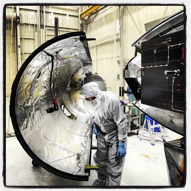 Orbital Sciences team members move the second half of the payload fairing before it is placed over NASA's IRIS (Interface Region Imaging Spectrograph) spacecraft. The fairing connects to the nose of the Orbital Sciences Pegasus XL rocket that will lift the solar observatory into orbit. The work is taking place in a hangar at Vandenberg Air Force Base, where IRIS is being prepared for launch on a Pegasus XL rocket.  Scheduled for launch from Vandenberg on June 26, 2013, IRIS will open a new window of discovery by tracing the flow of energy and plasma through the chromospheres and transition region into the sun's corona using spectrometry and imaging. IRIS fills a crucial gap in our ability to advance studies of the sun-to-Earth connection by tracing the flow of energy and plasma through the foundation of the corona and the region around the sun known as the heliosphere.  High res file available here: <a href="http://1.usa.gov/11yal3w" rel="nofollow">1.usa.gov/11yal3w</a>  Photo Credit: NASA/Tony Vauclin  <b><a href="http://www.nasa.gov/audience/formedia/features/MP_Photo_Guidelines.html" rel="nofollow">NASA image use policy.</a></b>  <b><a href="http://www.nasa.gov/centers/goddard/home/index.html" rel="nofollow">NASA Goddard Space Flight Center</a></b> enables NASA’s mission through four scientific endeavors: Earth Science, Heliophysics, Solar System Exploration, and Astrophysics. Goddard plays a leading role in NASA’s accomplishments by contributing compelling scientific knowledge to advance the Agency’s mission.  <b>Follow us on <a href="http://twitter.com/NASA_GoddardPix" rel="nofollow">Twitter</a></b>  <b>Like us on <a href="http://www.facebook.com/pages/Greenbelt-MD/NASA-Goddard/395013845897?ref=tsd" rel="nofollow">Facebook</a></b>  <b>Find us on <a href="http://instagram.com/nasagoddard?vm=grid" rel="nofollow">Instagram</a></b>