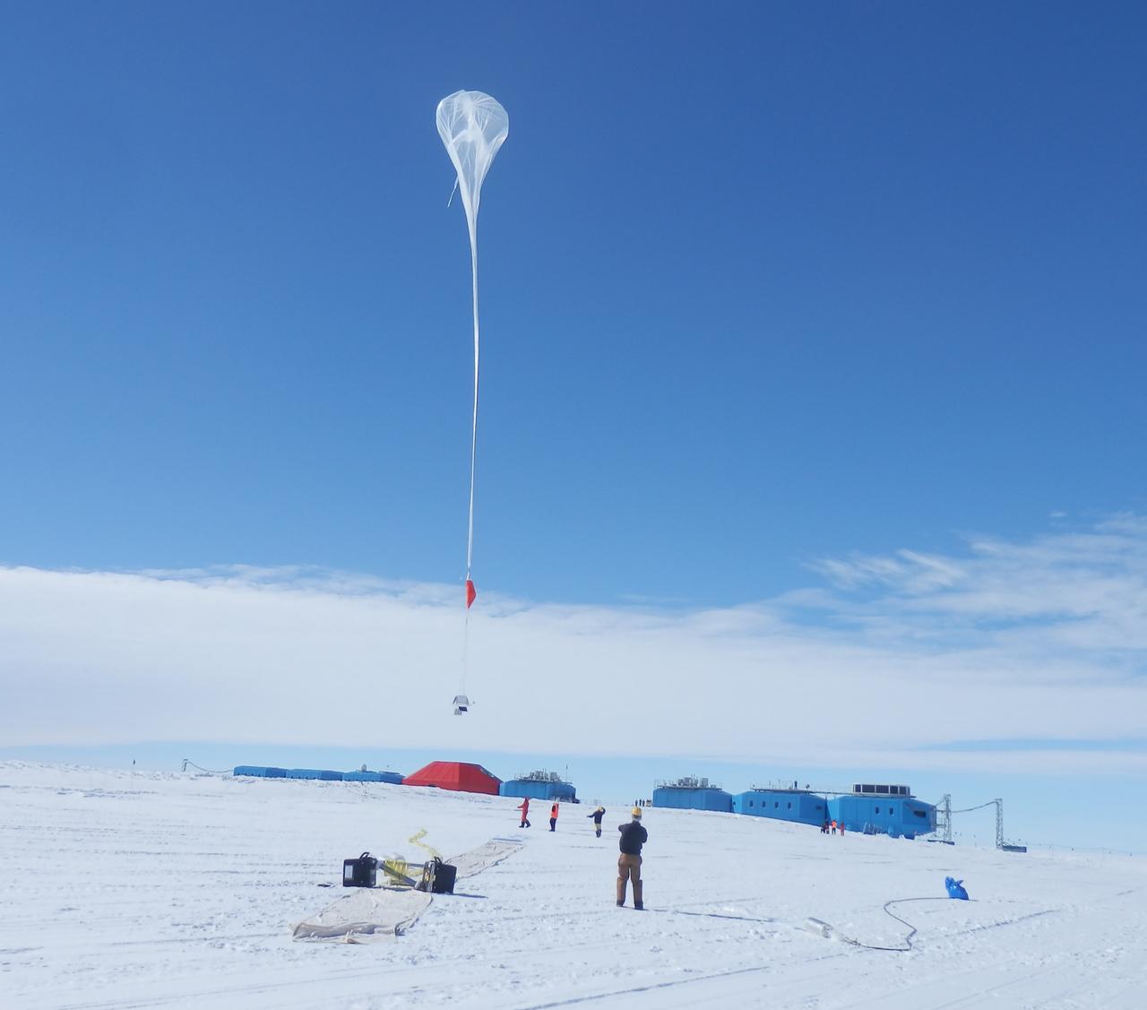 Liftoff!  A balloon begins to rise over the brand new Halley VI Research Station, which had its grand opening in February 2013.   Credit: NASA  ---  In Antarctica in January, 2013 – the summer at the South Pole – scientists launched 20 balloons up into the air to study an enduring mystery of space weather: when the giant radiation belts surrounding Earth lose material, where do the extra particles actually go? The mission is called BARREL (Balloon Array for Radiation belt Relativistic Electron Losses) and it is led by physicist Robyn Millan of Dartmouth College in Hanover, NH. Millan provided photographs from the team’s time in Antarctica.   The team launched a balloon every day or two into the circumpolar winds that circulate around the pole. Each balloon floated for anywhere from 3 to 40 days, measuring X-rays produced by fast-moving electrons high up in the atmosphere. BARREL works hand in hand with another NASA mission called the Van Allen Probes, which travels through the Van Allen radiation belts surrounding Earth. The belts wax and wane over time in response to incoming energy and material from the sun, sometimes intensifying the radiation through which satellites must travel. Scientists wish to understand this process better, and even provide forecasts of this space weather, in order to protect our spacecraft.   As the Van Allen Probes were observing what was happening in the belts, BARREL tracked electrons that precipitated out of the belts and hurtled down Earth’s magnetic field lines toward the poles. By comparing data, scientists will be able to track how what’s happening in the belts correlates to the loss of particles – information that can help us understand this mysterious, dynamic region that can impact spacecraft.   Having launched balloons in early 2013, the team is back at home building the next set of payloads. They will launch 20 more balloons in 2014.    <b><a href="http://www.nasa.gov/audience/formedia/features/MP_Photo_Guidelines.html" rel="nofollow">NASA image use policy.</a></b>  <b><a href="http://www.nasa.gov/centers/goddard/home/index.html" rel="nofollow">NASA Goddard Space Flight Center</a></b> enables NASA’s mission through four scientific endeavors: Earth Science, Heliophysics, Solar System Exploration, and Astrophysics. Goddard plays a leading role in NASA’s accomplishments by contributing compelling scientific knowledge to advance the Agency’s mission.  <b>Follow us on <a href="http://twitter.com/NASA_GoddardPix" rel="nofollow">Twitter</a></b>  <b>Like us on <a href="http://www.facebook.com/pages/Greenbelt-MD/NASA-Goddard/395013845897?ref=tsd" rel="nofollow">Facebook</a></b>  <b>Find us on <a href="http://instagram.com/nasagoddard?vm=grid" rel="nofollow">Instagram</a></b>