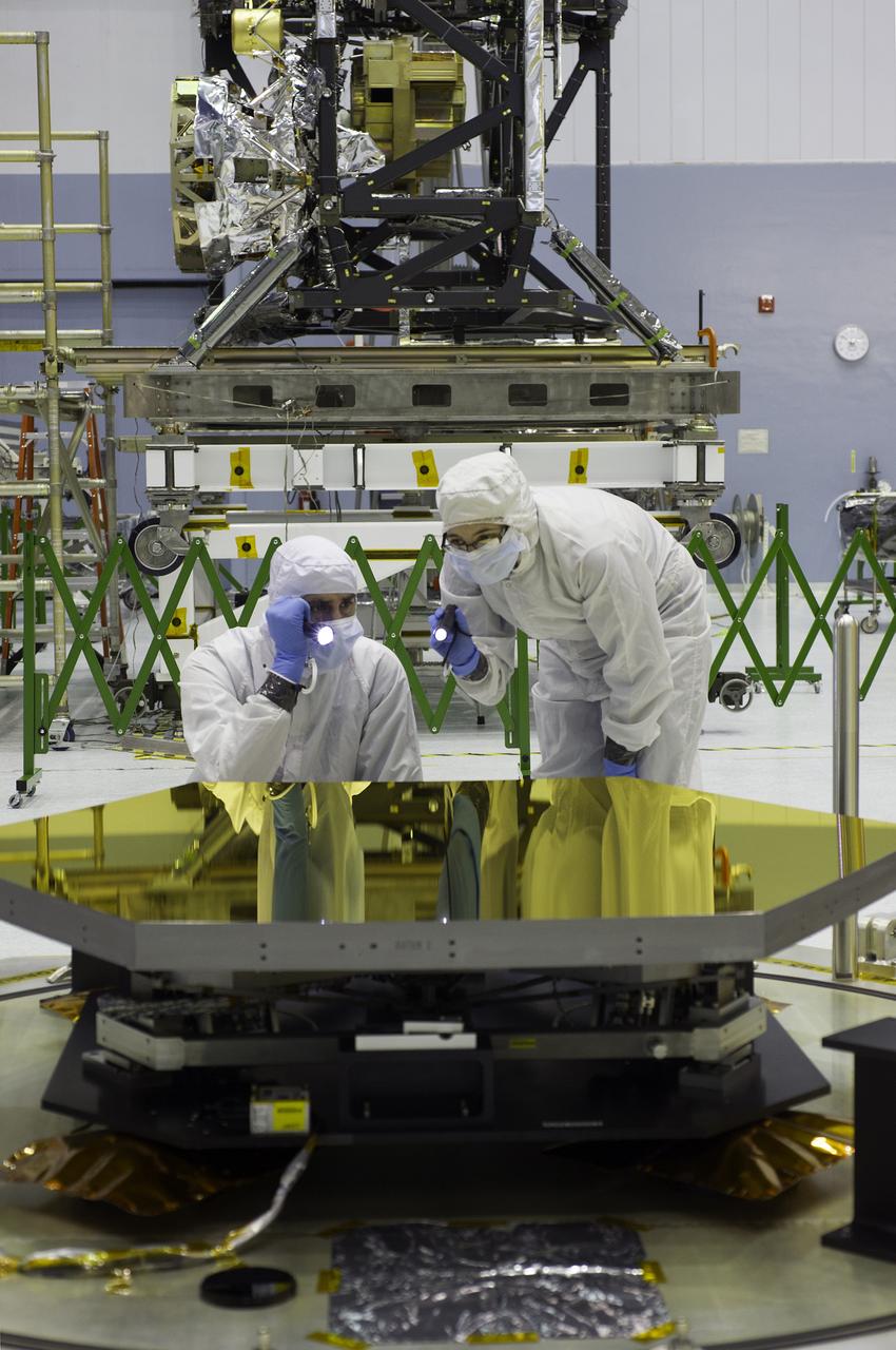  Webb telescope Quality Engineer Matt Magsamen and Product Assurance Engineer Jessica Lieberman inspect one of the primary mirror segments. The Webb telescope's third batch of flight mirrors now reside in the clean room at NASA's Goddard Space Flight Center in Greenbelt, Md. The latest arrivals included the seventh, eighth and ninth primary mirror segments.      Credit: NASA/Chris Gunn <b><a href="http://www.nasa.gov/audience/formedia/features/MP_Photo_Guidelines.html" rel="nofollow">NASA image use policy.</a></b>  <b><a href="http://www.nasa.gov/centers/goddard/home/index.html" rel="nofollow">NASA Goddard Space Flight Center</a></b> enables NASA’s mission through four scientific endeavors: Earth Science, Heliophysics, Solar System Exploration, and Astrophysics. Goddard plays a leading role in NASA’s accomplishments by contributing compelling scientific knowledge to advance the Agency’s mission.  <b>Follow us on <a href="http://twitter.com/NASA_GoddardPix" rel="nofollow">Twitter</a></b>  <b>Like us on <a href="http://www.facebook.com/pages/Greenbelt-MD/NASA-Goddard/395013845897?ref=tsd" rel="nofollow">Facebook</a></b>  <b>Find us on <a href="http://instagram.com/nasagoddard?vm=grid" rel="nofollow">Instagram</a></b>
