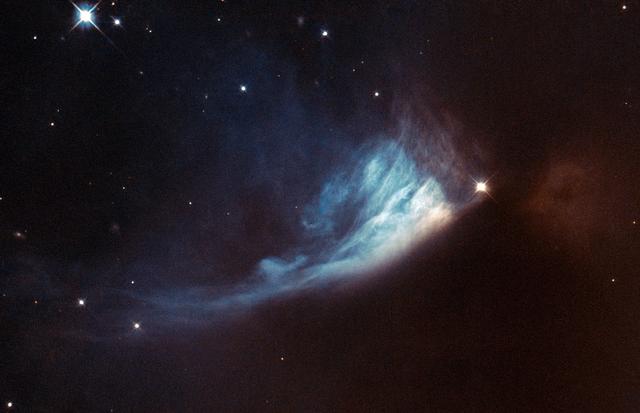 The Universe is rarely static, although the timescales involved can be very long. Since modern astronomical observations began we have been observing the birthplaces of new stars and planets, searching for and studying the subtle changes that help us to figure out what is happening within.  The bright spot located at the edge of the bluish fan-shaped structure in this Hubble image is a young star called V* PV Cephei, or PV Cep. It is a favorite target for amateur astronomers because the fan-shaped nebulosity, known as GM 1-29 or Gyulbudaghian’s Nebula, changes over a timescale of months. The brightness of the star has also varied over time.  Images of PV Cep taken in 1952 showed a nebulous streak, similar to a comet’s tail. However, this had vanished when new images of the star were obtained some twenty-five years later. Instead, the blue fan-shaped nebula had appeared. Twenty-five years is a very short period on cosmic timescales, so astronomers think that the mysterious streak may have been a temporary phenomenon, such as the remnants of a massive stellar flare — similar to the solar flares we are used to seeing in the solar system.  At the same time as this was happening, the star itself was brightening. This provided the light to illuminate the newly formed fan-shaped nebula. This brightening might be related to the start of the hydrogen-burning phase of the star, which would mean that it was reaching maturity.  PV Cep is thought to be surrounded by a disc of gas and dust, which would stop light from escaping in all directions. The fan-like appearance is therefore probably a result of starlight escaping from the dust disc and projecting onto the nebula.  PV Cep is located in the northern constellation of Cepheus at a distance of over 1600 light-years from Earth.   European Space Agency/NASA Hubble  <b><a href="http://www.nasa.gov/audience/formedia/features/MP_Photo_Guidelines.html" rel="nofollow">NASA image use policy.</a></b>  <b><a href="http://www.nasa.gov/centers/goddard/home/index.html" rel="nofollow">NASA Goddard Space Flight Center</a></b> enables NASA’s mission through four scientific endeavors: Earth Science, Heliophysics, Solar System Exploration, and Astrophysics. Goddard plays a leading role in NASA’s accomplishments by contributing compelling scientific knowledge to advance the Agency’s mission.  <b>Follow us on <a href="http://twitter.com/NASA_GoddardPix" rel="nofollow">Twitter</a></b>  <b>Like us on <a href="http://www.facebook.com/pages/Greenbelt-MD/NASA-Goddard/395013845897?ref=tsd" rel="nofollow">Facebook</a></b>  <b>Find us on <a href="http://instagram.com/nasagoddard?vm=grid" rel="nofollow">Instagram</a></b>