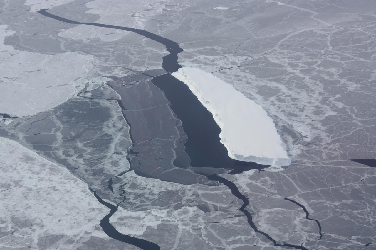 Iceberg embedded in sea ice with a lead on one side. This opening was likely caused by winds blowing against the side of the iceberg.   Credit: NASA / George Hale  NASA's Operation IceBridge is an airborne science mission to study Earth's polar ice. For more information about IceBridge, visit: <a href="http://www.nasa.gov/icebridge" rel="nofollow">www.nasa.gov/icebridge</a>  <b><a href="http://www.nasa.gov/audience/formedia/features/MP_Photo_Guidelines.html" rel="nofollow">NASA image use policy.</a></b>  <b><a href="http://www.nasa.gov/centers/goddard/home/index.html" rel="nofollow">NASA Goddard Space Flight Center</a></b> enables NASA’s mission through four scientific endeavors: Earth Science, Heliophysics, Solar System Exploration, and Astrophysics. Goddard plays a leading role in NASA’s accomplishments by contributing compelling scientific knowledge to advance the Agency’s mission.  <b>Follow us on <a href="http://twitter.com/NASA_GoddardPix" rel="nofollow">Twitter</a></b>  <b>Like us on <a href="http://www.facebook.com/pages/Greenbelt-MD/NASA-Goddard/395013845897?ref=tsd" rel="nofollow">Facebook</a></b>  <b>Find us on <a href="http://instagrid.me/nasagoddard/?vm=grid" rel="nofollow">Instagram</a></b>
