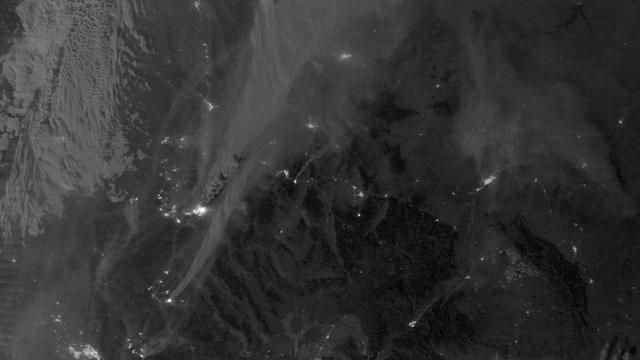 On August 29, 2012, the Visible Infrared Imaging Radiometer Suite (VIIRS) on the Suomi NPP satellite captured this nighttime view of wildfires burning in Idaho and Montana. The image was captured by the VIIRS “day-night band,” which detects light in a range of wavelengths from green to near-infrared and uses filtering techniques to observe signals such as gas flares, auroras, wildfires, city lights, and reflected moonlight. When the image was acquired, the moon was in its waxing gibbous phase, meaning it was more than half-lit, but less than full. Numerous hot spots from the Mustang Complex Fire are visible in northern Idaho. A plume of thick, billowing smoke streams west from the brightest fires near the Idaho-Montana border. The Halstead and Trinity Ridge fires are visible to the south. In addition to the fires, city lights from Boise and other smaller cities appear throughout the image. A bank of clouds is located west of the Mustang Complex, over southeastern Washington and northeastern Oregon. The Operational Line System (OLS)—an earlier generation of night-viewing sensors on the U.S. Defense Meteorological Satellite Program (DMSP) satellites—was also capable of detecting fires at night. But the VIIRS “day-night band” is far better than OLS at resolving them. Each pixel of an VIIRS image shows roughly 740 meters (0.46 miles), compared to the 3-kilometer footprint (1.86 miles) on the OLS system. NASA Earth Observatory image by Jesse Allen and Robert Simmon, using VIIRS Day-Night Band data from the Suomi National Polar-orbiting Partnership. Suomi NPP is the result of a partnership between NASA, the National Oceanic and Atmospheric Administration, and the Department of Defense. Caption by Adam Voiland. Instrument: Suomi NPP - VIIRS Credit: <b><a href="http://www.earthobservatory.nasa.gov/" rel="nofollow"> NASA Earth Observatory</a></b> <b>Click here to view all of the <a href="http://earthobservatory.nasa.gov/Features/NightLights/" rel="nofollow"> Earth at Night 2012 images </a></b> <b>Click here to <a href="http://earthobservatory.nasa.gov/NaturalHazards/view.php?id=79754" rel="nofollow"> read more </a> about this image </b> <b><a href="http://www.nasa.gov/audience/formedia/features/MP_Photo_Guidelines.html" rel="nofollow">NASA image use policy.</a></b> <b><a href="http://www.nasa.gov/centers/goddard/home/index.html" rel="nofollow">NASA Goddard Space Flight Center</a></b> enables NASA’s mission through four scientific endeavors: Earth Science, Heliophysics, Solar System Exploration, and Astrophysics. Goddard plays a leading role in NASA’s accomplishments by contributing compelling scientific knowledge to advance the Agency’s mission. <b>Follow us on <a href="http://twitter.com/NASA_GoddardPix" rel="nofollow">Twitter</a></b> <b>Like us on <a href="http://www.facebook.com/pages/Greenbelt-MD/NASA-Goddard/395013845897?ref=tsd" rel="nofollow">Facebook</a></b> <b>Find us on <a href="http://instagram.com/nasagoddard?vm=grid" rel="nofollow">Instagram</a></b>