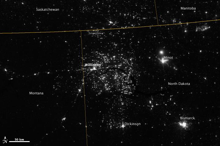 Northwestern North Dakota is one of the least-densely populated parts of the United States. Cities and people are scarce, but satellite imagery shows the area has been aglow at night in recent years. The reason: the area is home to the Bakken shale formation, a site where oil production is booming.  Companies hoping to extract oil from the Bakken formation have drilled hundreds of new wells in the last few years; natural gas often bubbles up to the surface as part of the process. Lacking the infrastructure to pipe the gas away, many drillers simply burn it in a practice known as flaring.  On November 12, 2012, the Visible Infrared Imaging Radiometer Suite (VIIRS) on the Suomi NPP satellite captured this nighttime view of widespread gas flaring throughout the area. Many of the specks of light are evidence of gas flaring, though others may be the lights around drilling equipment. Some of the brighter areas correspond to towns and cities including Williston, Minot, and Dickinson.  The image was captured by the VIIRS “day-night band,” which detects light in a range of wavelengths from green to near-infrared and uses filtering techniques to observe signals such as gas flares, auroras, wildfires, city lights, and reflected moonlight. When VIIRS acquired the image, the moon was in its waning crescent phase, meaning it was reflecting only a small amount of light.  According to the U.S. Energy Information Administration, natural gas production from the Bakken shale has increased more than 20-fold between 2007 and 2010. Gas production averaged over 485 million cubic feet per day in September 2011, compared to the 2005 average of about 160 million cubic feet per day. Due to the lack of gas pipeline and processing facilities in the region, about 29 percent of that gas is flared.   NASA Earth Observatory image by Jesse Allen and Robert Simmon, using VIIRS Day-Night Band data from the Suomi National Polar-orbiting Partnership. Suomi NPP is the result of a partnership between NASA, the National Oceanic and Atmospheric Administration, and the Department of Defense. Caption by Adam Voiland.  Instrument: Suomi NPP - VIIRS   Credit: <b><a href="http://www.earthobservatory.nasa.gov/" rel="nofollow"> NASA Earth Observatory</a></b>  <b>Click here to view all of the <a href="http://earthobservatory.nasa.gov/Features/NightLights/" rel="nofollow"> Earth at Night 2012 images </a></b>  <b>Click here to <a href="http://earthobservatory.nasa.gov/NaturalHazards/view.php?id=79810" rel="nofollow"> read more </a> about this image </b>   <b><a href="http://www.nasa.gov/audience/formedia/features/MP_Photo_Guidelines.html" rel="nofollow">NASA image use policy.</a></b>  <b><a href="http://www.nasa.gov/centers/goddard/home/index.html" rel="nofollow">NASA Goddard Space Flight Center</a></b> enables NASA’s mission through four scientific endeavors: Earth Science, Heliophysics, Solar System Exploration, and Astrophysics. Goddard plays a leading role in NASA’s accomplishments by contributing compelling scientific knowledge to advance the Agency’s mission.  <b>Follow us on <a href="http://twitter.com/NASA_GoddardPix" rel="nofollow">Twitter</a></b>  <b>Like us on <a href="http://www.facebook.com/pages/Greenbelt-MD/NASA-Goddard/395013845897?ref=tsd" rel="nofollow">Facebook</a></b>  <b>Find us on <a href="http://instagram.com/nasagoddard?vm=grid" rel="nofollow">Instagram</a></b>