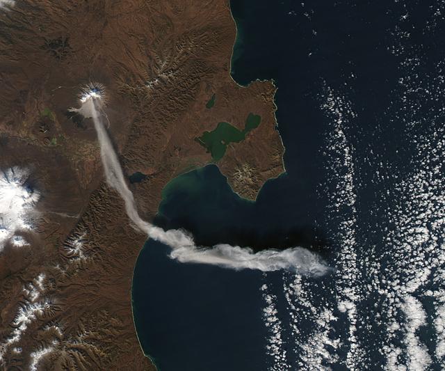 When NASA’s Terra satellite passed over Russia’s Kamchatka Peninsula at noon local time (00:00 Universal Time) on October 6, 2012, Shilveluch Volcano was quiet. By the time NASA’s Aqua satellite passed over the area two hours later (bottom image), the volcano had erupted and sent a plume of ash over the Kamchatskiy Zaliv. The plume traveled about 90 kilometers (55 miles) toward the south-southeast, where a change in wind direction began pushing the plume toward the east.  On October 6, 2012, the Kamchatka Volcanic Emergency Response Team (KVERT) reported that the ash plume from Shiveluch reached an altitude of 3 kilometers (9,800 feet) above sea level, and had traveled some 220 kilometers (140 miles) from the volcano summit.  Shiveluch (also spelled Sheveluch) ranks among the biggest and most active volcanoes on the Kamchatka Peninsula. Rising to 3,283 meters (10,771 feet) above sea level, Shiveluch is a stratovolcano composed of alternating layers of hardened lava, compacted ash, and rocks ejected by previous eruptions. The beige-colored expanse of rock on the volcano’s southern slopes (visible in both images) is due to an explosive eruption that occurred in 1964. Part of Shiveluch’s southern flank collapsed, and the light-colored rock is avalanche debris left by that event. High-resolution imagery of Shiveluch shows very little vegetation within that avalanche zone.  On October 6, 2012, KVERT cited observations from the Moderate Resolution Imaging Spectroradiometer (MODIS) instruments on Terra and Aqua in detecting the Shiveluch eruption. This was not the first time that MODIS observed a Shiveluch eruption shortly after it started. In 2007, MODIS captured an image within minutes of the eruption’s start, before winds could blow the ash away from the summit.  When NASA’s Terra satellite passed over Russia’s Kamchatka Peninsula at noon local time (00:00 Universal Time) on October 6, 2012, Shilveluch Volcano was quiet (top image). By the time NASA’s Aqua satellite passed over the area two hours later (bottom image), the volcano had erupted and sent a plume of ash over the Kamchatskiy Zaliv. The plume traveled about 90 kilometers (55 miles) toward the south-southeast, where a change in wind direction began pushing the plume toward the east.  On October 6, 2012, the Kamchatka Volcanic Emergency Response Team (KVERT) reported that the ash plume from Shiveluch reached an altitude of 3 kilometers (9,800 feet) above sea level, and had traveled some 220 kilometers (140 miles) from the volcano summit. Shiveluch (also spelled Sheveluch) ranks among the biggest and most active volcanoes on the Kamchatka Peninsula. Rising to 3,283 meters (10,771 feet) above sea level, Shiveluch is a stratovolcano composed of alternating layers of hardened lava, compacted ash, and rocks ejected by previous eruptions. The beige-colored expanse of rock on the volcano’s southern slopes (visible in both images) is due to an explosive eruption that occurred in 1964. Part of Shiveluch’s southern flank collapsed, and the light-colored rock is avalanche debris left by that event. High-resolution imagery of Shiveluch shows very little vegetation within that avalanche zone. On October 6, 2012, KVERT cited observations from the Moderate Resolution Imaging Spectroradiometer (MODIS) instruments on Terra and Aqua in detecting the Shiveluch eruption. This was not the first time that MODIS observed a Shiveluch eruption shortly after it started. In 2007, MODIS captured an image within minutes of the eruption’s start, before winds could blow the ash away from the summit.  Credit: <b><a href="http://www.earthobservatory.nasa.gov/" rel="nofollow"> NASA Earth Observatory</a></b>  <b><a href="http://www.nasa.gov/audience/formedia/features/MP_Photo_Guidelines.html" rel="nofollow">NASA image use policy.</a></b>  <b><a href="http://www.nasa.gov/centers/goddard/home/index.html" rel="nofollow">NASA Goddard Space Flight Center</a></b> enables NASA’s mission through four scientific endeavors: Earth Science, Heliophysics, Solar System Exploration, and Astrophysics. Goddard plays a leading role in NASA’s accomplishments by contributing compelling scientific knowledge to advance the Agency’s mission.  <b>Follow us on <a href="http://twitter.com/NASA_GoddardPix" rel="nofollow">Twitter</a></b>  <b>Like us on <a href="http://www.facebook.com/pages/Greenbelt-MD/NASA-Goddard/395013845897?ref=tsd" rel="nofollow">Facebook</a></b>  <b>Find us on <a href="http://instagrid.me/nasagoddard/?vm=grid" rel="nofollow">Instagram</a></b>
