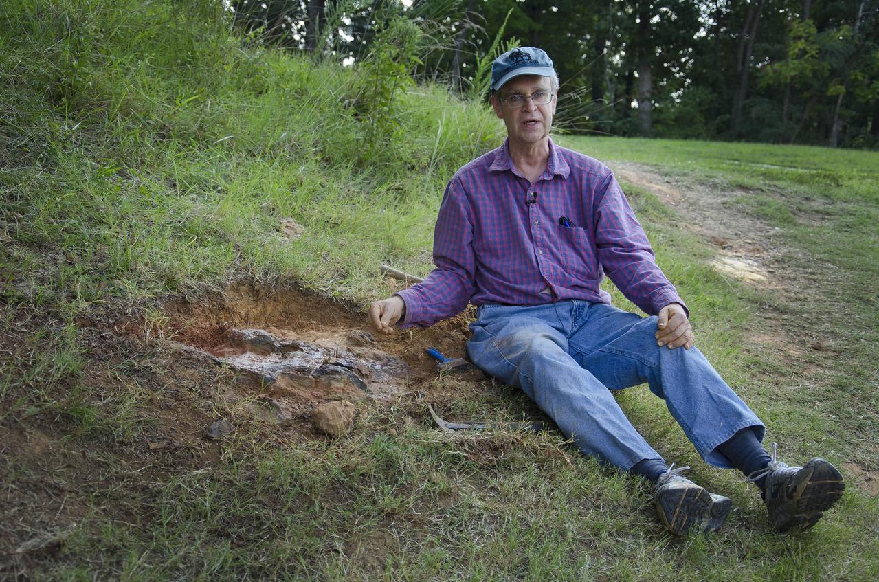 Dr. Robert Weems, emeritus paleontologist for the USGS verifies the recently discovered dinosaur track found on the NASA Goddard Space Flight Center campus.  This imprint shows the right rear foot of a nodosaur - a low-slung, spiny leaf-eater - apparently moving in haste as the heel did not fully settle in the cretaceous mud, according to dinosaur tracker Ray Stanford. It was found recently on NASA's Goddard Space Flight Center campus and is being preserved for study.   To read more about this discovery go to: <a href="http://1.usa.gov/P9NYg7" rel="nofollow">1.usa.gov/P9NYg7</a>  Credit: NASA/GSFC/Rebecca Roth  <b><a href="http://www.nasa.gov/audience/formedia/features/MP_Photo_Guidelines.html" rel="nofollow">NASA image use policy.</a></b>  <b><a href="http://www.nasa.gov/centers/goddard/home/index.html" rel="nofollow">NASA Goddard Space Flight Center</a></b> enables NASA’s mission through four scientific endeavors: Earth Science, Heliophysics, Solar System Exploration, and Astrophysics. Goddard plays a leading role in NASA’s accomplishments by contributing compelling scientific knowledge to advance the Agency’s mission.  <b>Follow us on <a href="http://twitter.com/NASA_GoddardPix" rel="nofollow">Twitter</a></b>  <b>Like us on <a href="http://www.facebook.com/pages/Greenbelt-MD/NASA-Goddard/395013845897?ref=tsd" rel="nofollow">Facebook</a></b>  <b>Find us on <a href="http://instagrid.me/nasagoddard/?vm=grid" rel="nofollow">Instagram</a></b>