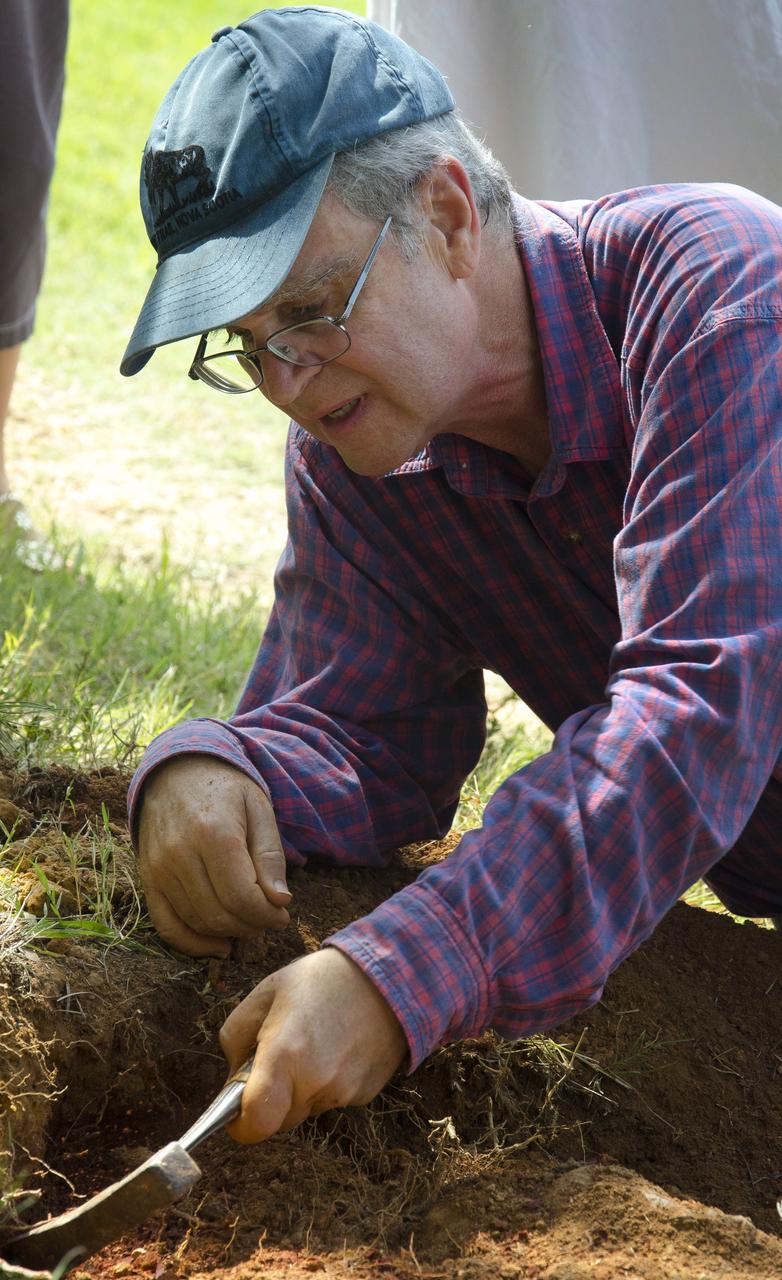 Dr. Robert Weems, emeritus paleontologist for the USGS verifies the recently discovered dinosaur track found on the NASA Goddard Space Flight Center campus.  This imprint shows the right rear foot of a nodosaur - a low-slung, spiny leaf-eater - apparently moving in haste as the heel did not fully settle in the cretaceous mud, according to dinosaur tracker Ray Stanford. It was found recently on NASA's Goddard Space Flight Center campus and is being preserved for study.   To read more about this discovery go to: <a href="http://1.usa.gov/P9NYg7" rel="nofollow">1.usa.gov/P9NYg7</a>  Credit: NASA/GSFC/Rebecca Roth  <b><a href="http://www.nasa.gov/audience/formedia/features/MP_Photo_Guidelines.html" rel="nofollow">NASA image use policy.</a></b>  <b><a href="http://www.nasa.gov/centers/goddard/home/index.html" rel="nofollow">NASA Goddard Space Flight Center</a></b> enables NASA’s mission through four scientific endeavors: Earth Science, Heliophysics, Solar System Exploration, and Astrophysics. Goddard plays a leading role in NASA’s accomplishments by contributing compelling scientific knowledge to advance the Agency’s mission.  <b>Follow us on <a href="http://twitter.com/NASA_GoddardPix" rel="nofollow">Twitter</a></b>  <b>Like us on <a href="http://www.facebook.com/pages/Greenbelt-MD/NASA-Goddard/395013845897?ref=tsd" rel="nofollow">Facebook</a></b>  <b>Find us on <a href="http://instagrid.me/nasagoddard/?vm=grid" rel="nofollow">Instagram</a></b>