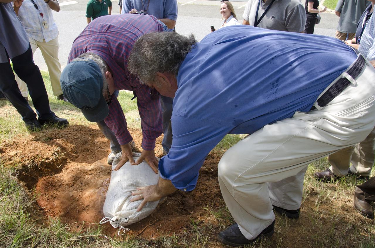 On Friday, Aug. 17, 2012, noted dinosaur hunter Ray Stanford shared the location of that footprint with Goddard’s facility management.  The imprint shows the right rear foot of a nodosaur - a low-slung, spiny leaf-eater - apparently moving in haste as the heel did not fully settle in the cretaceous mud, according to dinosaur tracker Ray Stanford. It was found recently on NASA's Goddard Space Flight Center campus and is being preserved for study.   Picuted here are Dr. Robert  Weems, emeritus paleontologist for the USGS and Goddard Facilities Planner Alan Binstock, covering the newly discover nodosaur imprint with a sandbag to help preserve the imprecision.  To read more go to: <a href="http://1.usa.gov/P9NYg7" rel="nofollow">1.usa.gov/P9NYg7</a>  Credit: NASA/GSFC/Rebecca Roth  <b><a href="http://www.nasa.gov/audience/formedia/features/MP_Photo_Guidelines.html" rel="nofollow">NASA image use policy.</a></b>  <b><a href="http://www.nasa.gov/centers/goddard/home/index.html" rel="nofollow">NASA Goddard Space Flight Center</a></b> enables NASA’s mission through four scientific endeavors: Earth Science, Heliophysics, Solar System Exploration, and Astrophysics. Goddard plays a leading role in NASA’s accomplishments by contributing compelling scientific knowledge to advance the Agency’s mission.  <b>Follow us on <a href="http://twitter.com/NASA_GoddardPix" rel="nofollow">Twitter</a></b>  <b>Like us on <a href="http://www.facebook.com/pages/Greenbelt-MD/NASA-Goddard/395013845897?ref=tsd" rel="nofollow">Facebook</a></b>  <b>Find us on <a href="http://instagrid.me/nasagoddard/?vm=grid" rel="nofollow">Instagram</a></b>