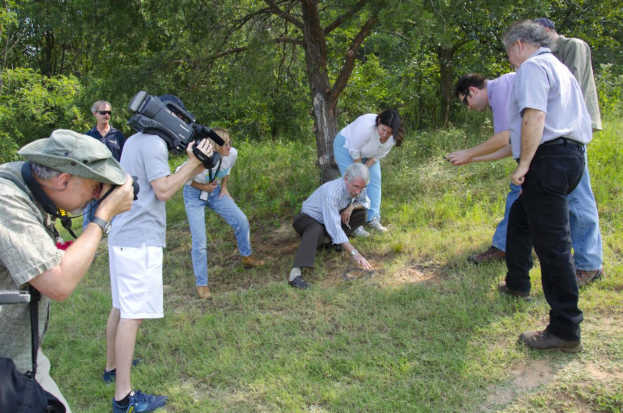About 110 million light years away, the bright, barred spiral galaxy NGC3259 was just forming stars in dark bands of dust and gas. On Earth, a plant-eating dinosaur left footprints in the Cretaceous mud of what would later become the grounds of NASA’s Goddard Space Flight Center in Greenbelt, Md. Local dinosaur hunter Ray Stanford points out the impression to Goddard officials and members of local media. <b>To read more go to: <a href="http://www.nasa.gov/centers/goddard/news/features/2012/nodosaur.html" rel="nofollow">www.nasa.gov/centers/goddard/news/features/2012/nodosaur....</a></b> Credit: NASA/Goddard/Rebecca Roth <b><a href="http://www.nasa.gov/audience/formedia/features/MP_Photo_Guidelines.html" rel="nofollow">NASA image use policy.</a></b> <b><a href="http://www.nasa.gov/centers/goddard/home/index.html" rel="nofollow">NASA Goddard Space Flight Center</a></b> enables NASA’s mission through four scientific endeavors: Earth Science, Heliophysics, Solar System Exploration, and Astrophysics. Goddard plays a leading role in NASA’s accomplishments by contributing compelling scientific knowledge to advance the Agency’s mission. <b>Follow us on <a href="http://twitter.com/NASA_GoddardPix" rel="nofollow">Twitter</a></b> <b>Like us on <a href="http://www.facebook.com/pages/Greenbelt-MD/NASA-Goddard/395013845897?ref=tsd" rel="nofollow">Facebook</a></b> <b>Find us on <a href="http://instagrid.me/nasagoddard/?vm=grid" rel="nofollow">Instagram</a></b>