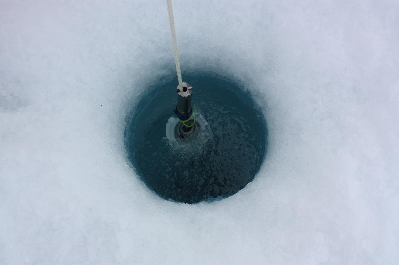 On July 6, 2011, ICESCAPE scientists lowered optical instruments through a hole at the bottom of a melt pond, to study the waters underneath the ice.  The ICESCAPE mission, or &quot;Impacts of Climate on Ecosystems and Chemistry of the Arctic Pacific Environment,&quot; is a NASA shipborne investigation to study how changing conditions in the Arctic affect the ocean's chemistry and ecosystems. The bulk of the research took place in the Beaufort and Chukchi seas in summer 2010 and 2011. Credit: NASA/Kathryn Hansen  <b><a href="http://www.nasa.gov/audience/formedia/features/MP_Photo_Guidelines.html" rel="nofollow">NASA image use policy.</a></b>  <b><a href="http://www.nasa.gov/centers/goddard/home/index.html" rel="nofollow">NASA Goddard Space Flight Center</a></b> enables NASA’s mission through four scientific endeavors: Earth Science, Heliophysics, Solar System Exploration, and Astrophysics. Goddard plays a leading role in NASA’s accomplishments by contributing compelling scientific knowledge to advance the Agency’s mission.  <b>Follow us on <a href="http://twitter.com/NASA_GoddardPix" rel="nofollow">Twitter</a></b>  <b>Like us on <a href="http://www.facebook.com/pages/Greenbelt-MD/NASA-Goddard/395013845897?ref=tsd" rel="nofollow">Facebook</a></b>  <b>Find us on <a href="http://instagrid.me/nasagoddard/?vm=grid" rel="nofollow">Instagram</a></b>