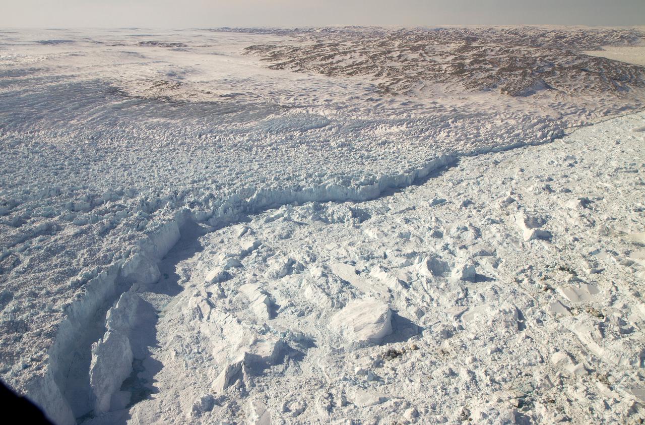 The calving front of the Jakobshavn Glacier in western Greenland, as seen from NASA's P-3B aircraft on April 21, 2012.   Credit: NASA/GSFC/Jefferson Beck  ===========  IceBridge, a six-year NASA mission, is the largest airborne survey of Earth's polar ice ever flown. It will yield an unprecedented three-dimensional view of Arctic and Antarctic ice sheets, ice shelves and sea ice. These flights will provide a yearly, multi-instrument look at the behavior of the rapidly changing features of the Greenland and Antarctic ice.  Data collected during IceBridge will help scientists bridge the gap in polar observations between NASA's Ice, Cloud and Land Elevation Satellite (ICESat) -- in orbit since 2003 -- and ICESat-2, planned for early 2016. ICESat stopped collecting science data in 2009, making IceBridge critical for ensuring a continuous series of observations.  IceBridge will use airborne instruments to map Arctic and Antarctic areas once a year. IceBridge flights are conducted in March-May over Greenland and in October-November over Antarctica. Other smaller airborne surveys around the world are also part of the IceBridge campaign.  To read more about IceBridge - Arctic 2012 go to: <a href="http://www.nasa.gov/mission_pages/icebridge/index.html" rel="nofollow">www.nasa.gov/mission_pages/icebridge/index.html</a>   <b><a href="http://www.nasa.gov/audience/formedia/features/MP_Photo_Guidelines.html" rel="nofollow">NASA image use policy.</a></b>  <b><a href="http://www.nasa.gov/centers/goddard/home/index.html" rel="nofollow">NASA Goddard Space Flight Center</a></b> enables NASA’s mission through four scientific endeavors: Earth Science, Heliophysics, Solar System Exploration, and Astrophysics. Goddard plays a leading role in NASA’s accomplishments by contributing compelling scientific knowledge to advance the Agency’s mission.  <b>Follow us on <a href="http://twitter.com/NASA_GoddardPix" rel="nofollow">Twitter</a></b>  <b>Like us on <a href="http://www.facebook.com/pages/Greenbelt-MD/NASA-Goddard/395013845897?ref=tsd" rel="nofollow">Facebook</a></b>  <b>Find us on <a href="http://instagrid.me/nasagoddard/?vm=grid" rel="nofollow">Instagram</a></b>