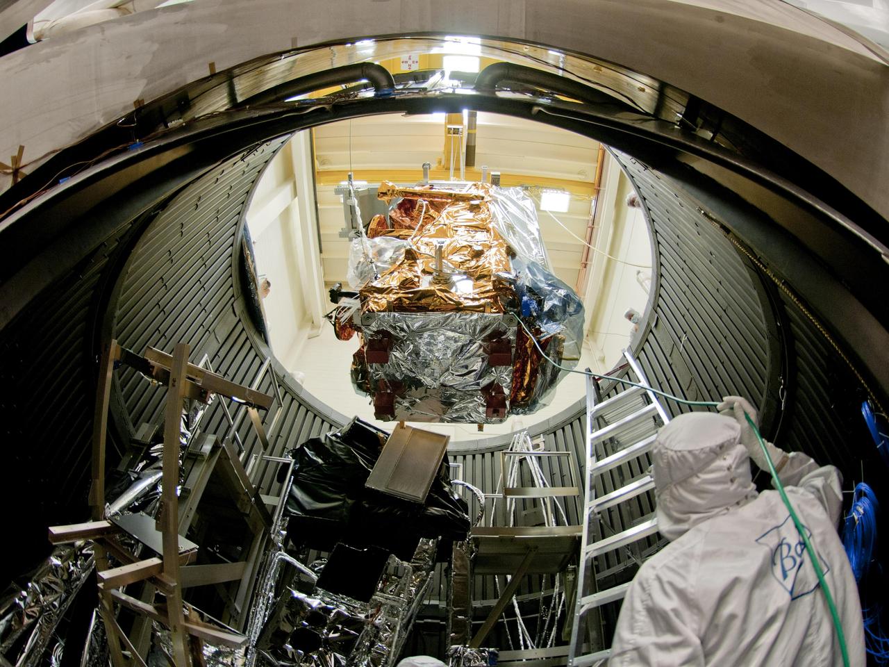 NPP is lowered into the thermal vacuum chamber. Once inside the Iron Maiden (visible in the lower left) is fitted in place. Then air is pumped out of the chamber and temperature extremes are applied to replicate orbit conditions.   Credit: Ball Aerospace  The NPP satellite sits surrounded by 144 rock concert speakers. They're stacked in a circle 16 feet high in a testing room at Ball Aerospace in Boulder, Colorado.   As engineers set up for the environmental test, Pink Floyd's song &quot;Money&quot; plays gently in the background. The music stops. The room clears. Then the sound engineer wearing earplugs and headphones in the control room next door flips a switch.   Slowly, the noise of thousands of pounds of exploding rocket fuel builds louder and louder until it blasts the satellite at a deafening 143.6 decibels -- loud enough to cause serious damage and pain to unprotected ears. &quot;I was outside the building when they did the full level acoustics,&quot; says Glenn Iona, NPP Chief Engineer at NASA Goddard Space Flight Center, Greenbelt, Md. &quot;and I could feel the ground shaking.&quot;   To read more go to: <a href="http://www.nasa.gov/mission_pages/NPP/news/npp-testing.html" rel="nofollow">www.nasa.gov/mission_pages/NPP/news/npp-testing.html</a>  <b><a href="http://www.nasa.gov/centers/goddard/home/index.html" rel="nofollow">NASA Goddard Space Flight Center</a></b> enables NASA’s mission through four scientific endeavors: Earth Science, Heliophysics, Solar System Exploration, and Astrophysics. Goddard plays a leading role in NASA’s accomplishments by contributing compelling scientific knowledge to advance the Agency’s mission.  <b>Follow us on <a href="http://twitter.com/NASA_GoddardPix" rel="nofollow">Twitter</a></b>  <b>Like us on <a href="http://www.facebook.com/pages/Greenbelt-MD/NASA-Goddard/395013845897?ref=tsd" rel="nofollow">Facebook</a></b>  <b>Find us on <a href="http://web.stagram.com/n/nasagoddard/?vm=grid" rel="nofollow">Instagram</a></b>