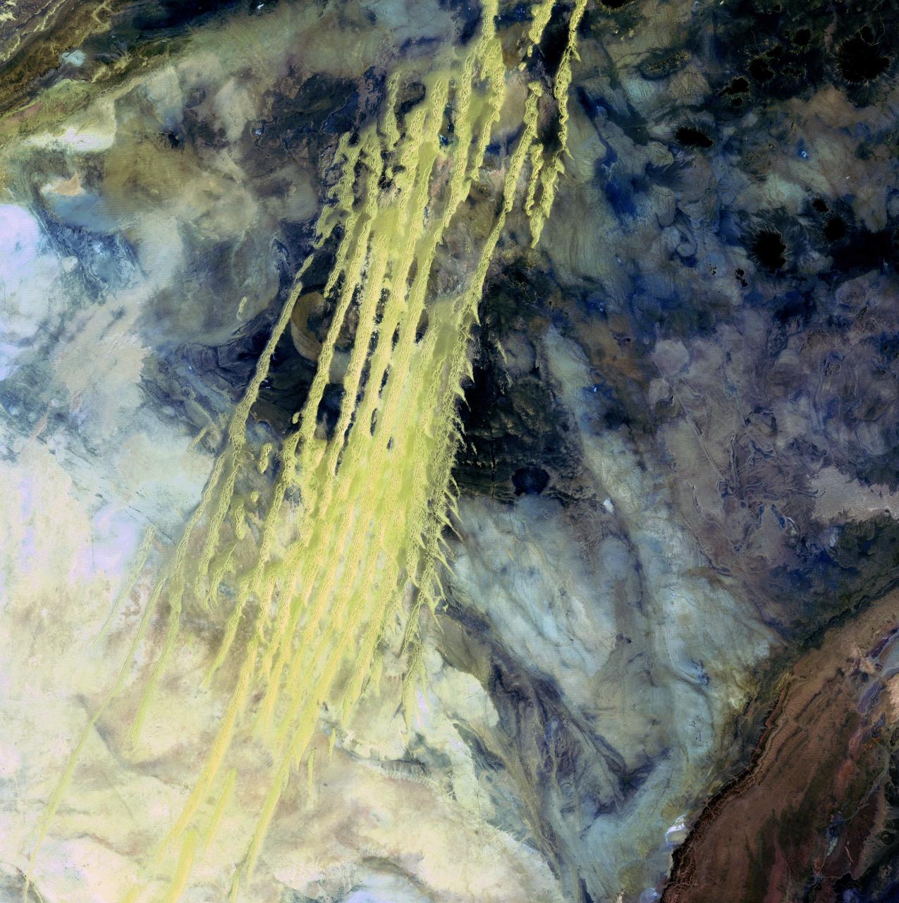 Algerian Abstract - April 8th, 1985  Description: What look like pale yellow paint streaks slashing through a mosaic of mottled colors are ridges of wind-blown sand that make up Erg Iguidi, an area of ever-shifting sand dunes extending from Algeria into Mauritania in northwestern Africa. Erg Iguidi is one of several Saharan ergs, or sand seas, where individual dunes often surpass 500 meters-nearly a third of a mile-in both width and height.  Credit: USGS/NASA/Landsat 5  To learn more about the Landsat satellite go to: <a href="http://landsat.gsfc.nasa.gov/" rel="nofollow">landsat.gsfc.nasa.gov/</a>  <b><a href="http://www.nasa.gov/centers/goddard/home/index.html" rel="nofollow">NASA Goddard Space Flight Center</a></b> enables NASA’s mission through four scientific endeavors: Earth Science, Heliophysics, Solar System Exploration, and Astrophysics. Goddard plays a leading role in NASA’s accomplishments by contributing compelling scientific knowledge to advance the Agency’s mission.  <b>Follow us on <a href="http://twitter.com/NASA_GoddardPix" rel="nofollow">Twitter</a></b>  <b>Join us on <a href="http://www.facebook.com/pages/Greenbelt-MD/NASA-Goddard/395013845897?ref=tsd" rel="nofollow">Facebook</a></b>