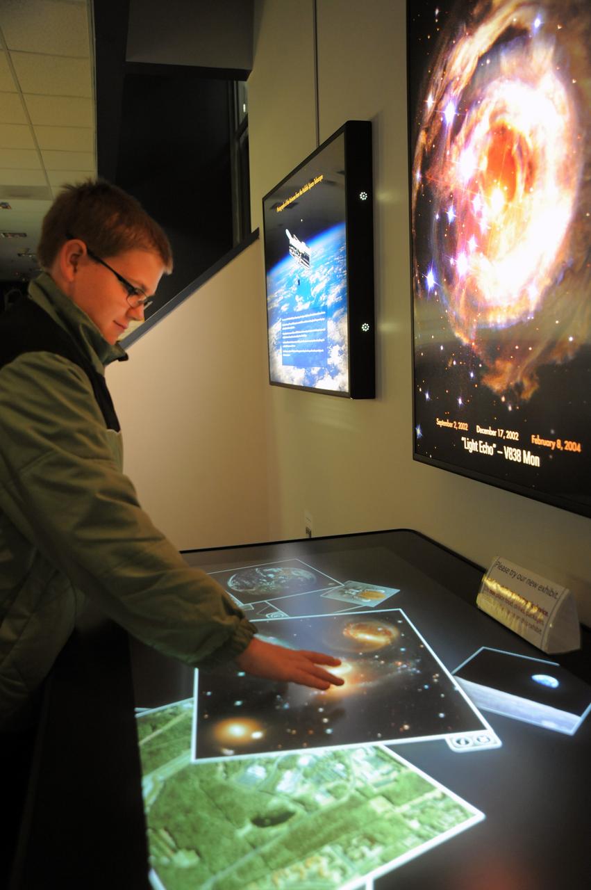 Visitor at touch display at VC.   Credit: NASA/GSFC/Debbie Mccallum  On September 18, 2010 the world joined the NASA Goddard Space Flight Center's Visitor Center in Greenbelt, Md., as well as other NASA Centers to celebrate the first annual International Observe the Moon Night (InOMN).  To read more go to: <a href="http://www.nasa.gov/centers/goddard/news/features/2010/moon-night.html" rel="nofollow">www.nasa.gov/centers/goddard/news/features/2010/moon-nigh...</a>  <b><a href="http://www.nasa.gov/centers/goddard/home/index.html" rel="nofollow">NASA Goddard Space Flight Center</a></b>  contributes to NASA’s mission through four scientific endeavors: Earth Science, Heliophysics, Solar System Exploration, and Astrophysics. Goddard plays a leading role in NASA’s endeavors by providing compelling scientific knowledge to advance the Agency’s mission.  <b>Follow us on <a href="http://twitter.com/NASA_GoddardPix" rel="nofollow">Twitter</a></b>  <b>Join us on <a href="http://www.facebook.com/pages/Greenbelt-MD/NASA-Goddard/395013845897?ref=tsd" rel="nofollow">Facebook</a></b>