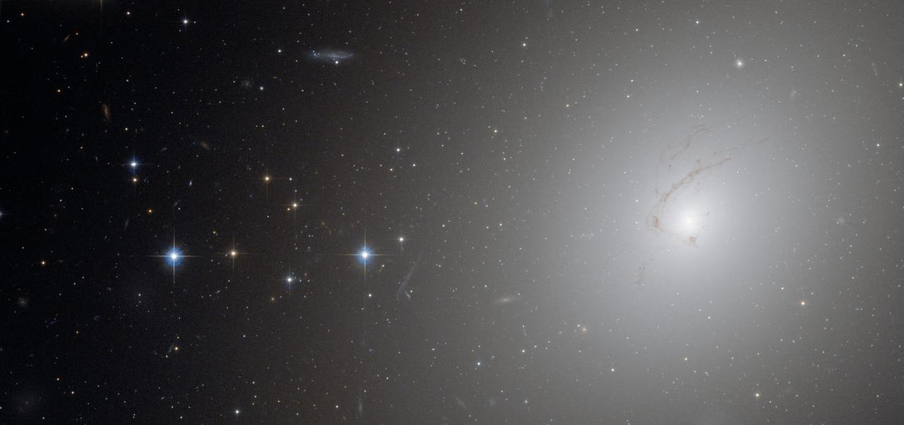This picture, taken by Hubble’s Advanced Camera for Surveys, shows NGC 4696, the largest galaxy in the Centaurus Cluster.  (To see a video of NGC 4696 go here: <a href="http://www.flickr.com/photos/gsfc/4888176841/)">www.flickr.com/photos/gsfc/4888176841/)</a>    The huge dust lane, around 30 000 light-years across, that sweeps across the face of the galaxy makes NGC 4696 look different from most other elliptical galaxies. Viewed at certain wavelengths, strange thin filaments of ionised hydrogen are visible within it. In this picture, these structures are visible as a subtle marbling effect across the galaxy’s bright centre.  Credit:  ESA/Hubble and NASA  <b><a href="http://www.nasa.gov/centers/goddard/home/index.html" rel="nofollow">NASA Goddard Space Flight Center</a></b>  is home to the nation's largest organization of combined scientists, engineers and technologists that build spacecraft, instruments and new technology to study the Earth, the sun, our solar system, and the universe.  <b>Follow us on <a href="http://twitter.com/NASA_GoddardPix" rel="nofollow">Twitter</a></b>  <b>Join us on <a href="http://www.facebook.com/pages/Greenbelt-MD/NASA-Goddard/395013845897?ref=tsd" rel="nofollow">Facebook</a><b></b></b>