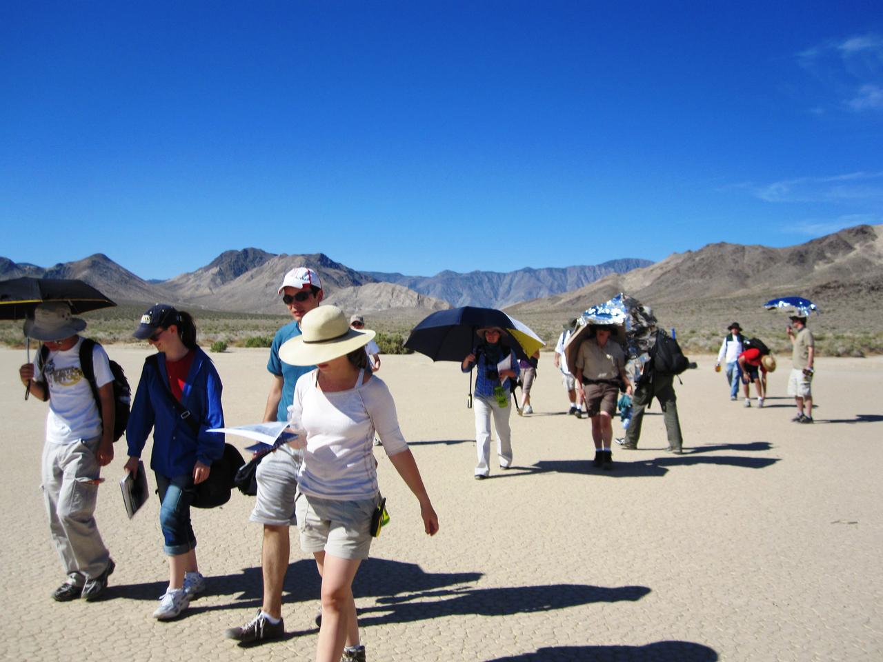 The summer interns with the 2010 Lunar and Planetary Science Academy (LPSA) at NASA's Goddard Space Flight Center came to study the Racetrack Playa rocks. Photo credit: NASA/GSFC/Mindy Krzykowski/LPSA intern To read a feature story on the Racetrack Playa go to: <a href="http://www.nasa.gov/topics/earth/features/roving-rocks.html" rel="nofollow">www.nasa.gov/topics/earth/features/roving-rocks.html</a> <b><a href="http://www.nasa.gov/centers/goddard/home/index.html" rel="nofollow">NASA Goddard Space Flight Center</a></b> is home to the nation's largest organization of combined scientists, engineers and technologists that build spacecraft, instruments and new technology to study the Earth, the sun, our solar system, and the universe. <b>Follow us on <a href="http://twitter.com/NASA_GoddardPix" rel="nofollow">Twitter</a></b> <b>Join us on <a href="http://www.facebook.com/pages/Greenbelt-MD/NASA-Goddard/395013845897?ref=tsd" rel="nofollow">Facebook</a><b></b></b>